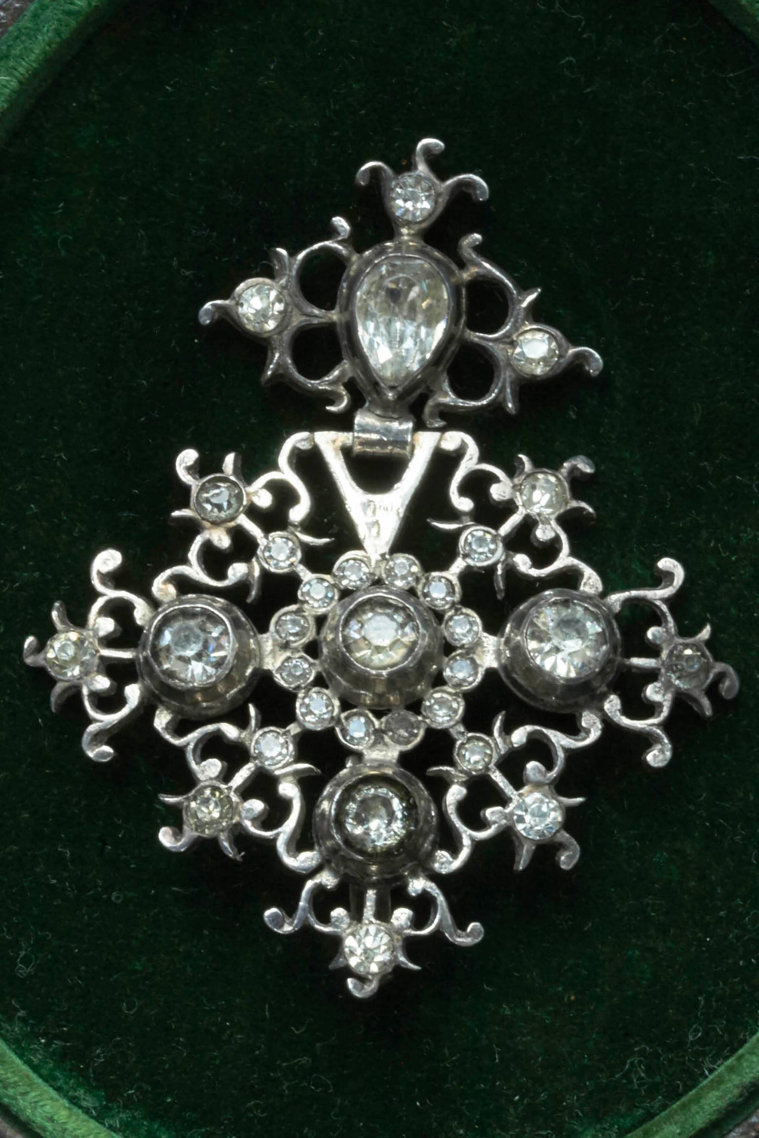C.1800.  A Georgian silver and paste pendant. French in origin. The paste stones are foil-backed. There is a loop in the back to put through a ribbon for your neck. There is an illegible mark on the back of the pendant.
A very wearable piece with