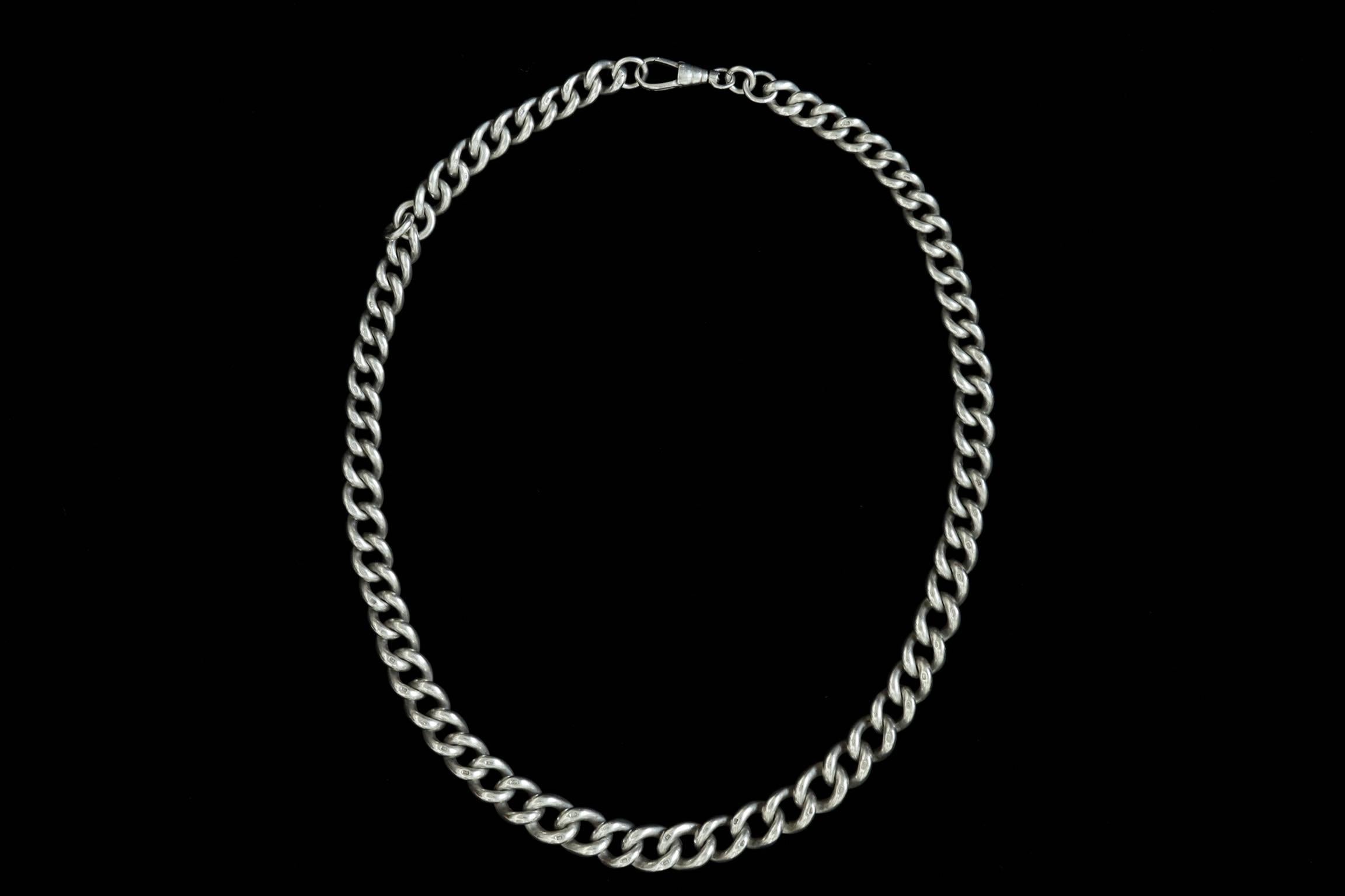 A very substantial and chunky Edwardian sterling silver Albert chain. The chain once was used for mens watch chain. It contains the original dog clip to add fobs, pendants or charms, and works as a wonderful necklace with a bold appearance. It