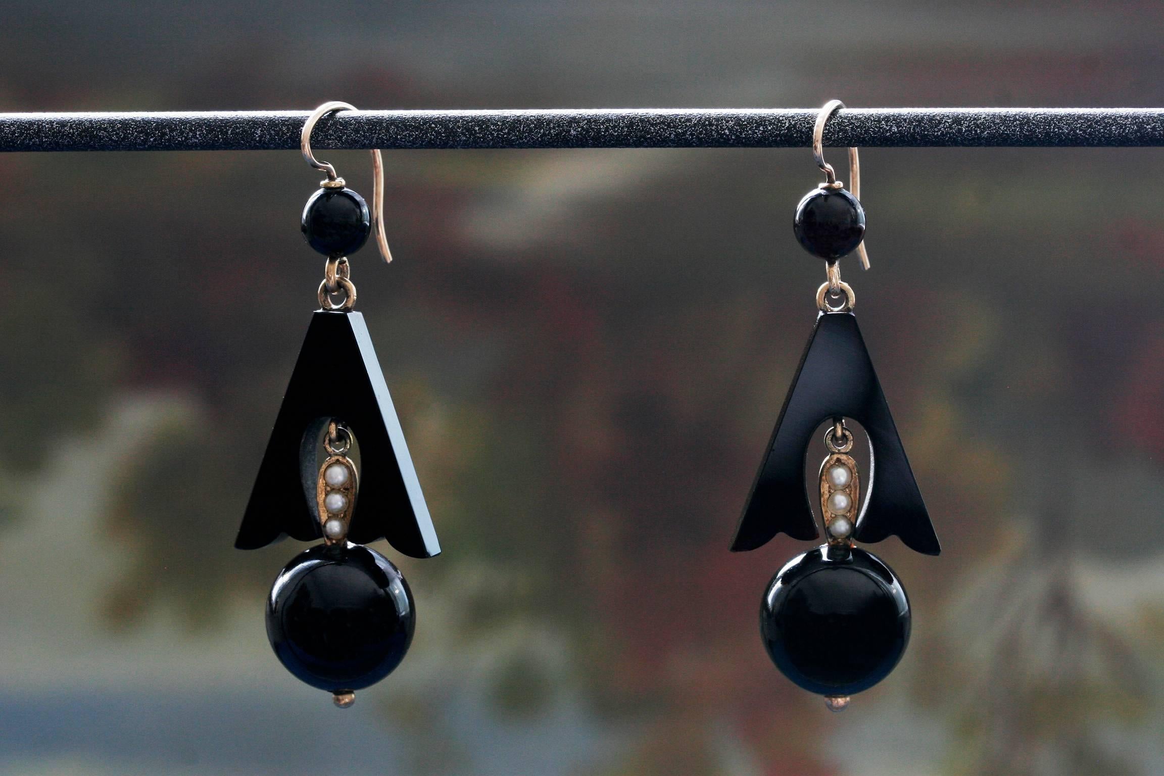 C.1880-1890.  A pair of Victorian onyx and seed pearl earrings. They measure approximately 1.5 inches, and have beautiful movement when worn. Set in 14k gold, and seed pearls are all intact. Overall in very good condition.