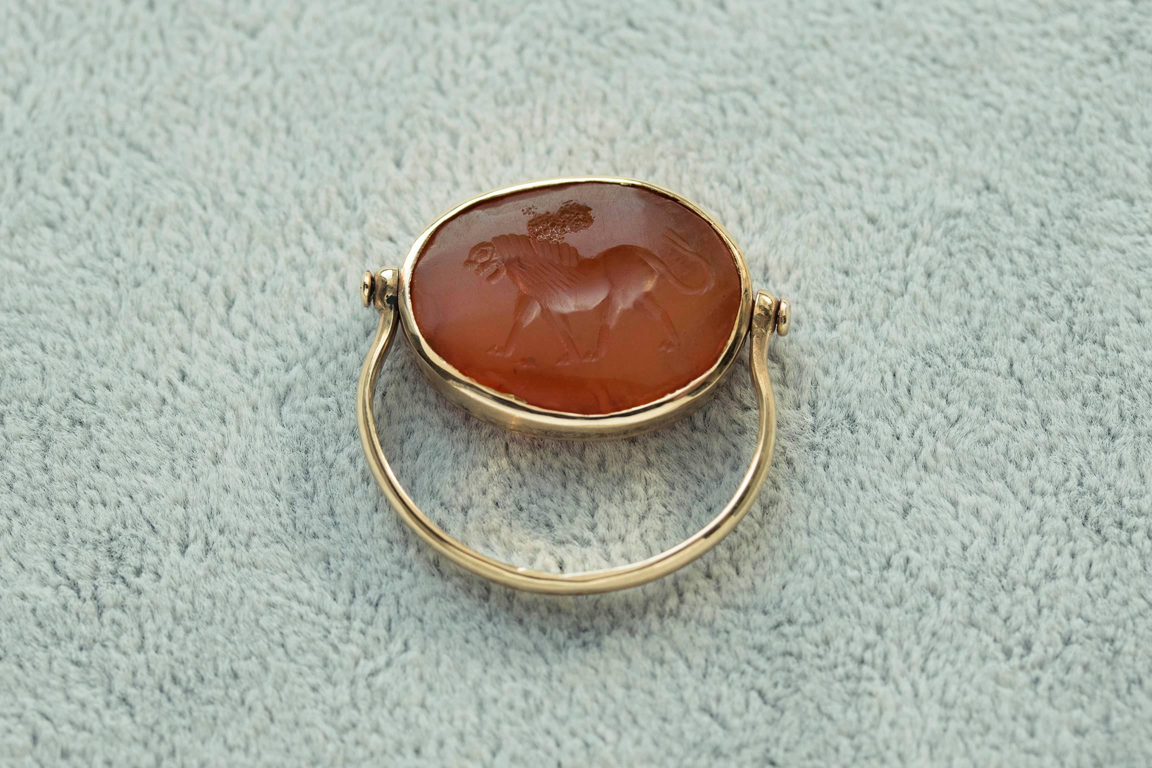 An impressive Sasanian (Neo-Persian, a.k.a Sassanian) lion intaglio ring. This carnelian intaglio is circa 600 A.D, and the oldest one we've had. The ring is set with a contemporary 18k yellow gold swivel mounting. Lion symbolizes power, strength