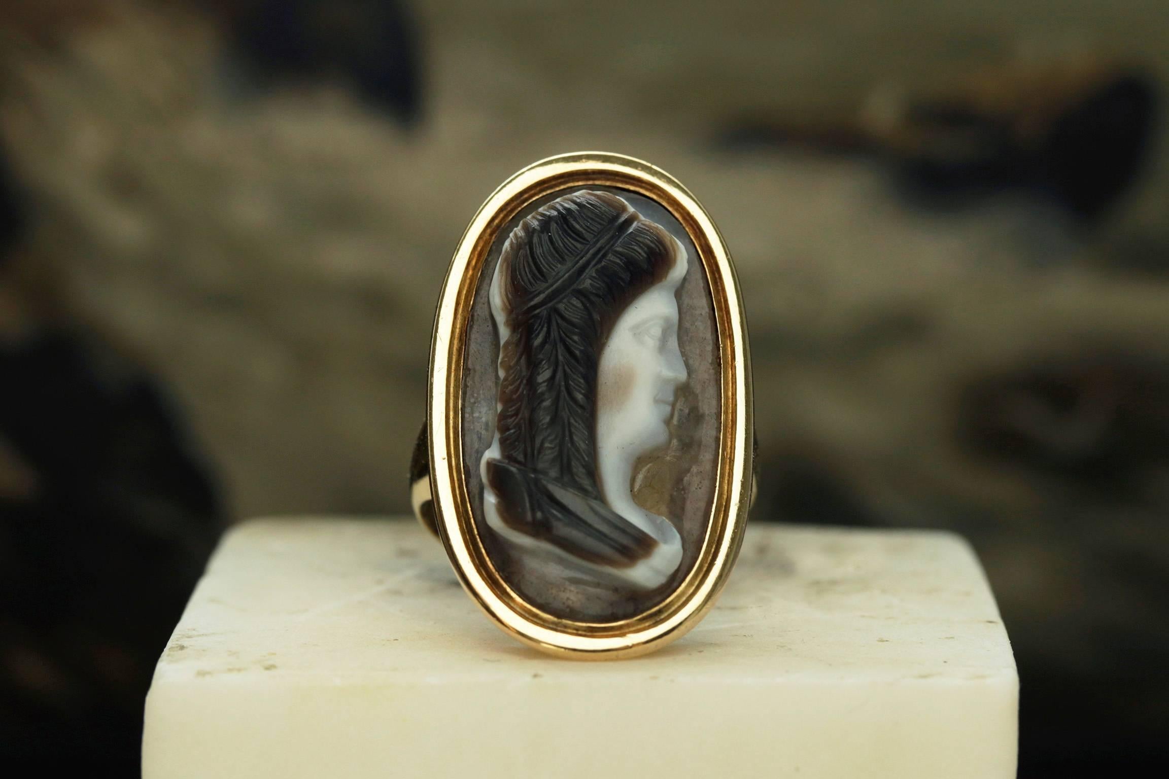 C.1820. Georgian sardonyx cameo ring. The carving was done in three strata. The carver has utilized the striations in the stone to create a color contrast between the subject's face and hair. Large in scale, the ring offers a significant appearance,