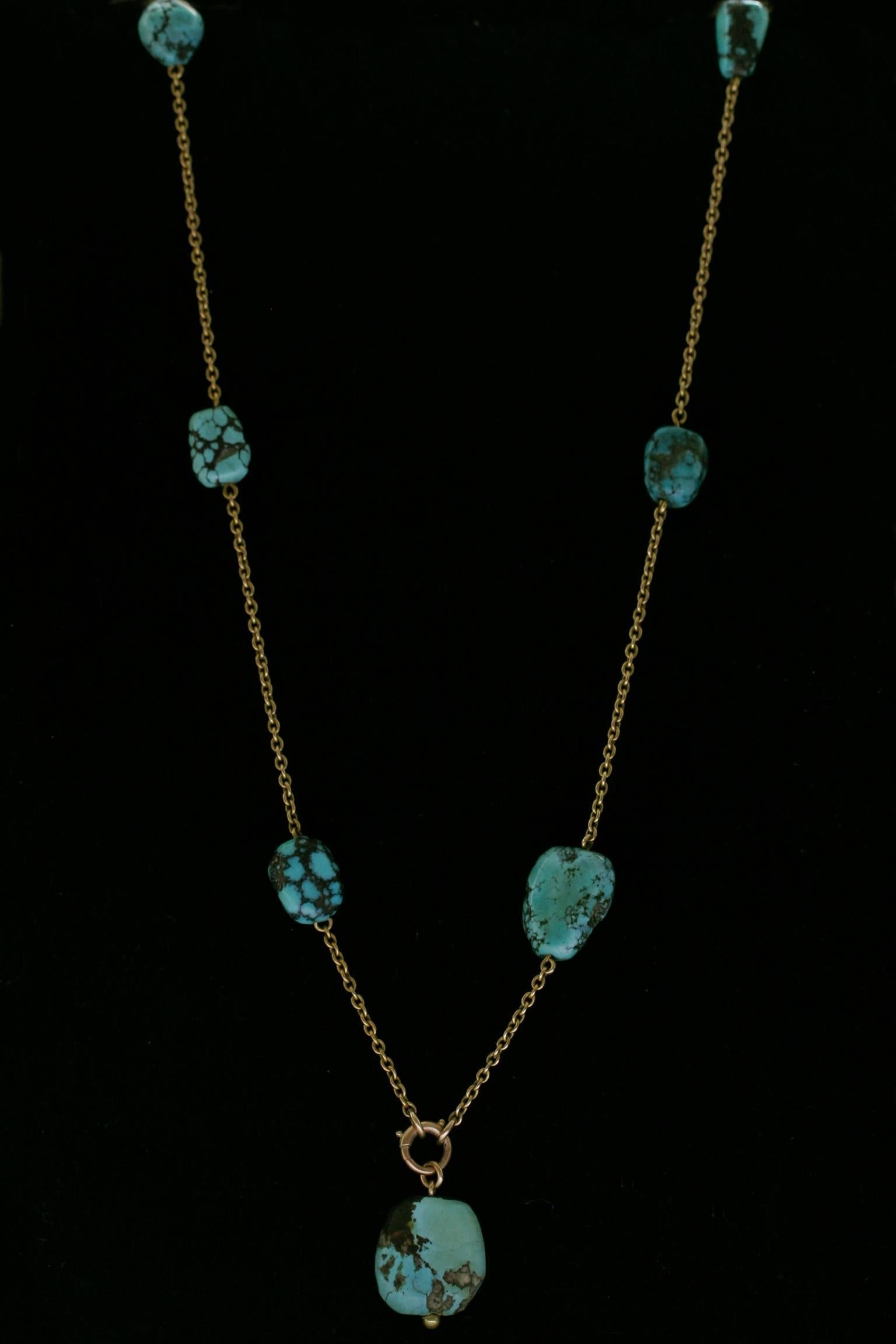 An Edwardian era 18k yellow gold and turquoise nugget necklace of fine quality. The bolt ring tests at 14k gold. The necklace also works beautifully without the large drop stone, which can be easily removed. It measures approximately 29 inches in