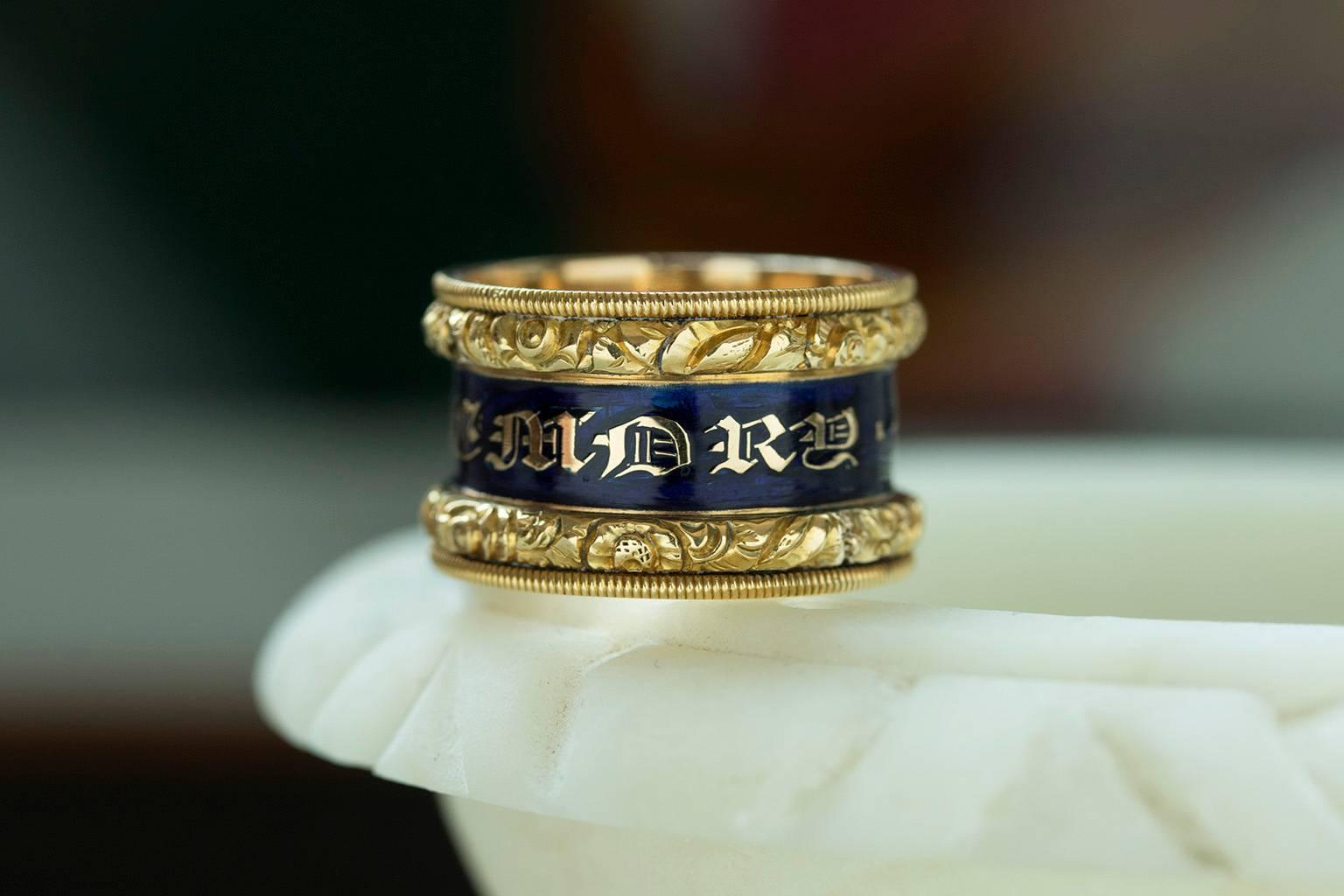 C.1821. A wide Georgian blue enamel memorial ring. The gothic script reads 'In Memory Of' through the band. The top and bottom edges are beautifully carved, and the engraving inside shows 'Ann Page Ob. 6 aug 1821 Aet 74