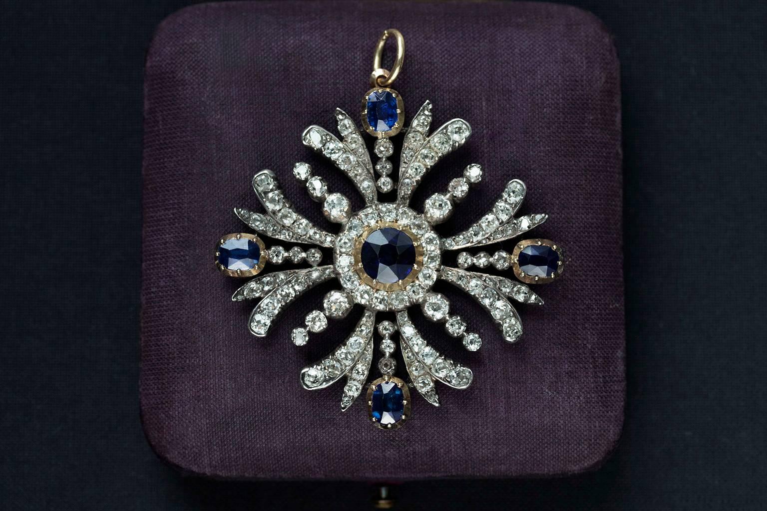 C.1840. A gorgeous early Victorian sapphire and diamond pendant. The openwork mount old mine-cut diamonds are set with a central circular cut sapphire weighting approximately 2.25cts within a diamond border, with further single cushion-shaped