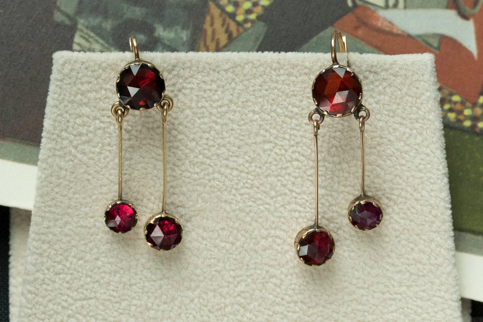Late 19th century French Perpignan garnet earrings. The garnets are foil-backed, and the rose cut facets make them shimmer beautifully with light. The earrings are set in 18k gold. They are lightweight and easy to wear. Overall in very good