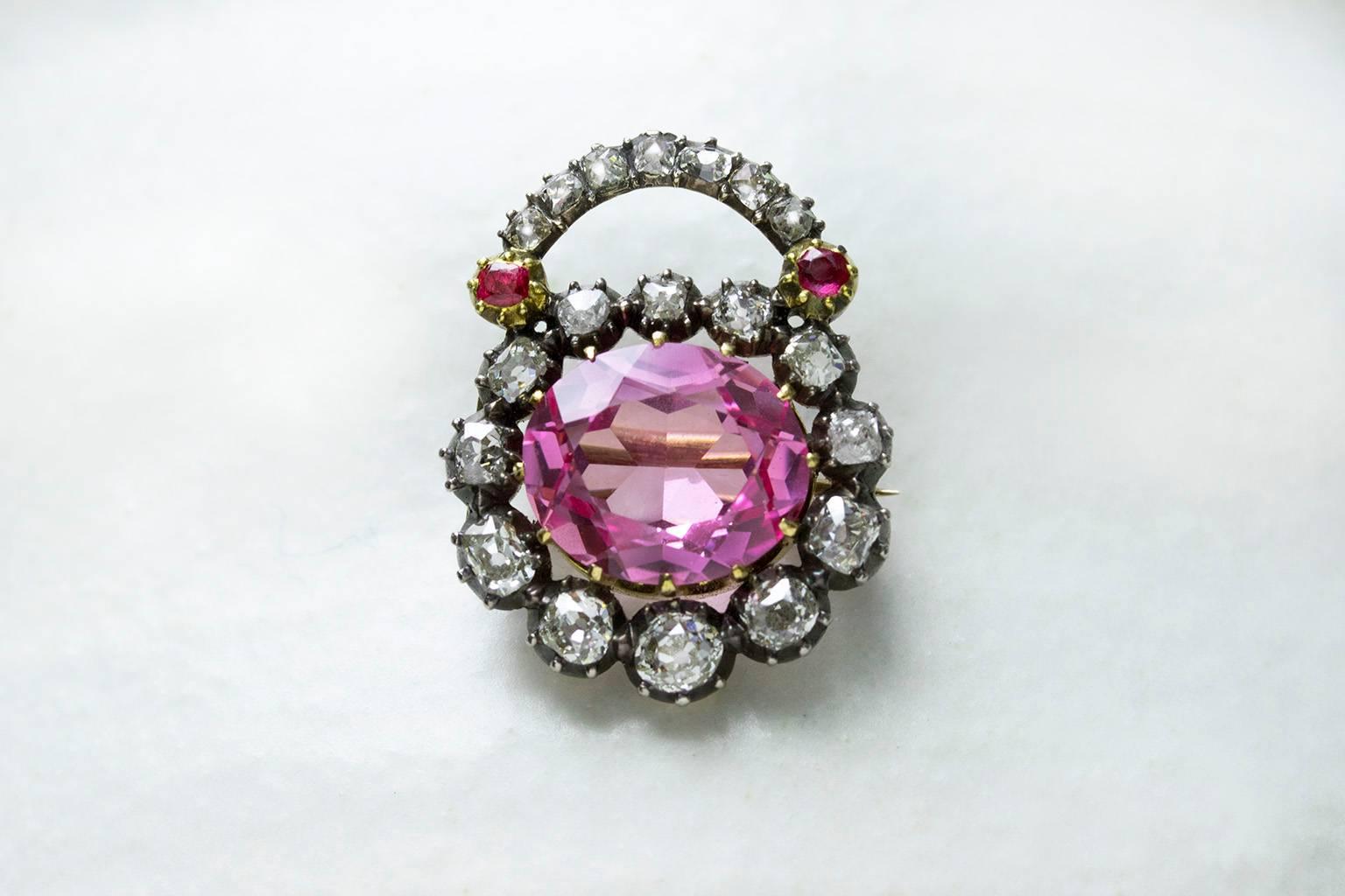C.1820. A very pretty English diamond padlock pin/pendant. The padlock is made of 19 sparkly diamonds (7 old European and 12 old mine cut), and the center stone is an early 20th century synthetic pink sapphire in the size of 5.06 ct, which was most