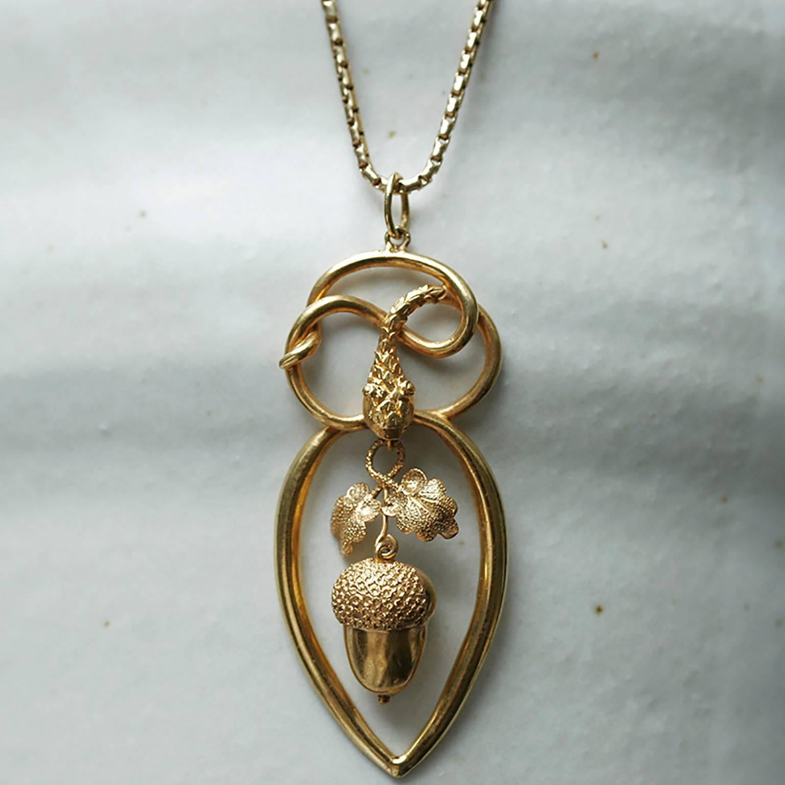 C.1860.  An enchanting example of Victorian jewelry: a serpent and dangling acorn pendant. The coiled body of a serpent forms the top part of the pendant; the serpent’s mouth holds an acorn with the leaves. The acorn and the leaves sway delightfully