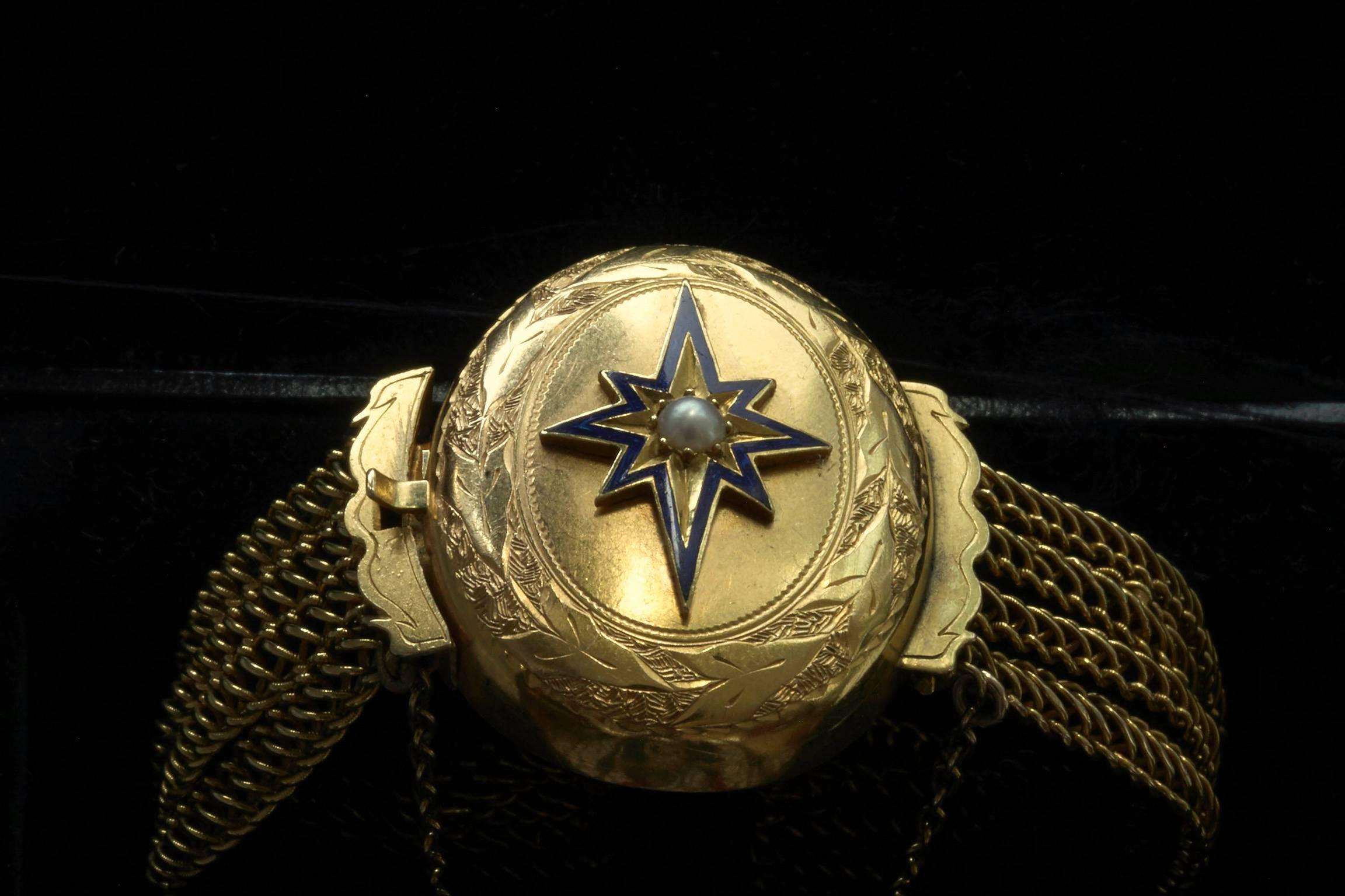 C.1880. An amazingly handsome late Victorian bracelet with a hidden glass locket on the back. The locket is connected to four loose gold chains on each side. The hidden locket currently contains two locks of hair, but it can easily be removed if