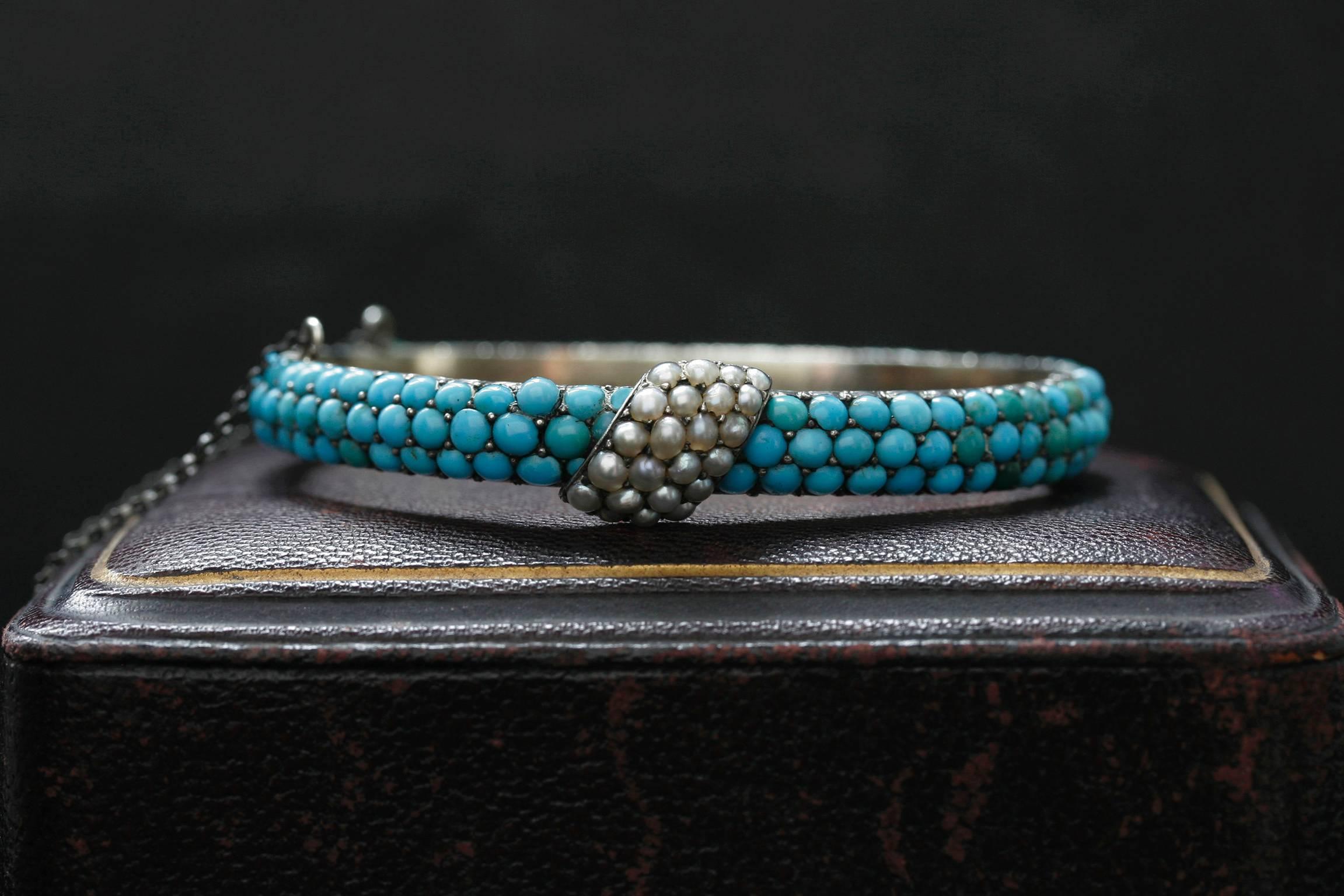 Beautifully made Victorian bangle with Persian turquoises and seed pearls laid over sterling silver. Simple and elegant in design, yet having stones continue all the way around the back gives it a fancier look. The bangle has a sterling silver