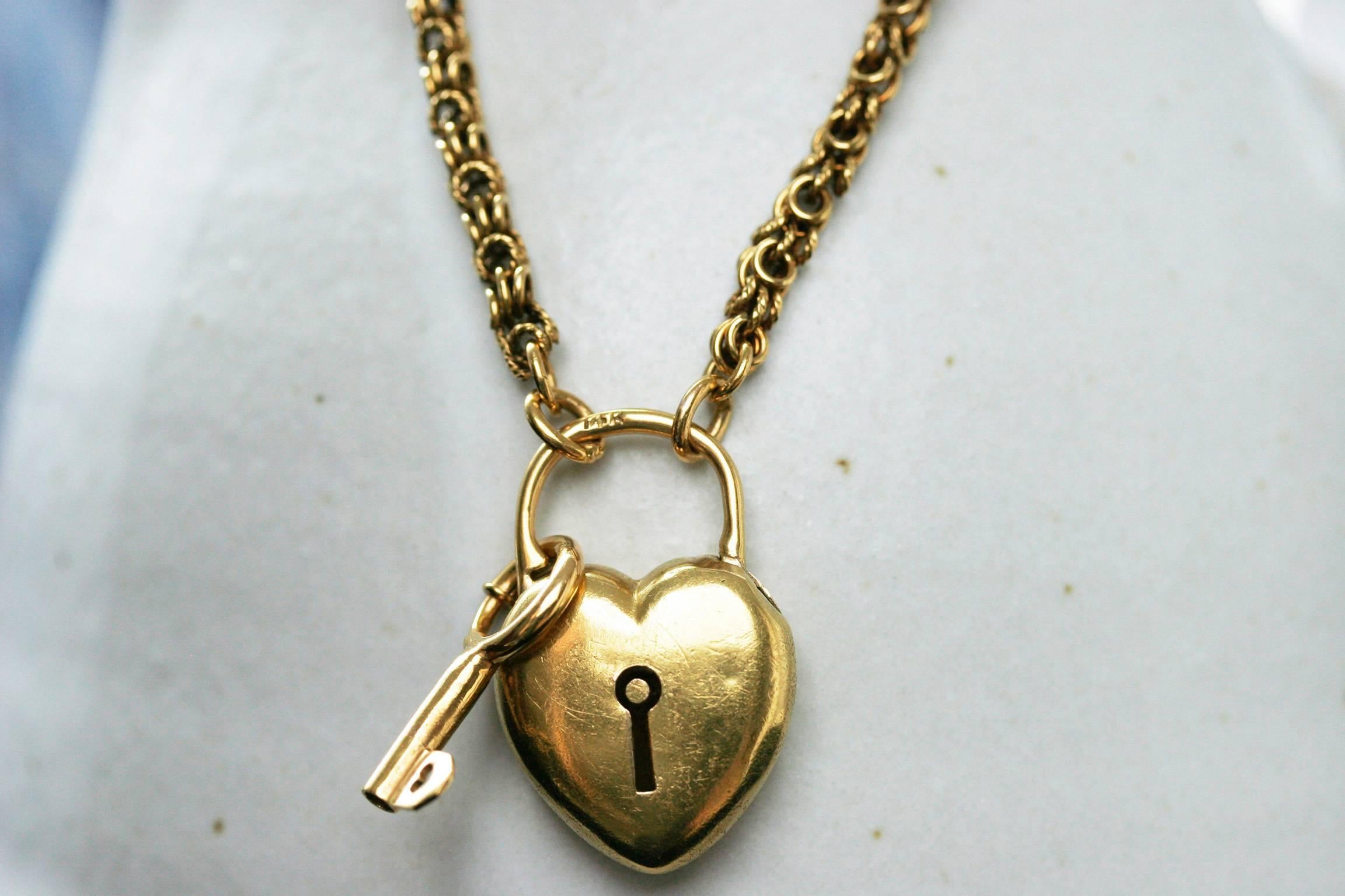 C.1870. Endearing Victorian heart padlock necklace. The padlock and the key are attached to a beautiful 14k rich yellow gold Victorian chain. The padlock is also crafted out of 14k yellow gold (hallmarked). The key also has a lovely detail of