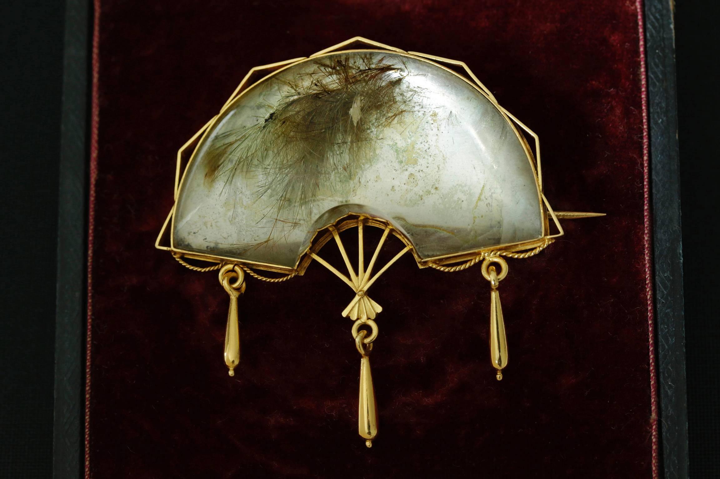 This is an amazing example of how the Victorians used the materials and shapes together. Rutilated quartz are often called 'hair crystal' because of its natural inclusions. This case, this the quartz has organically formed some feather-like