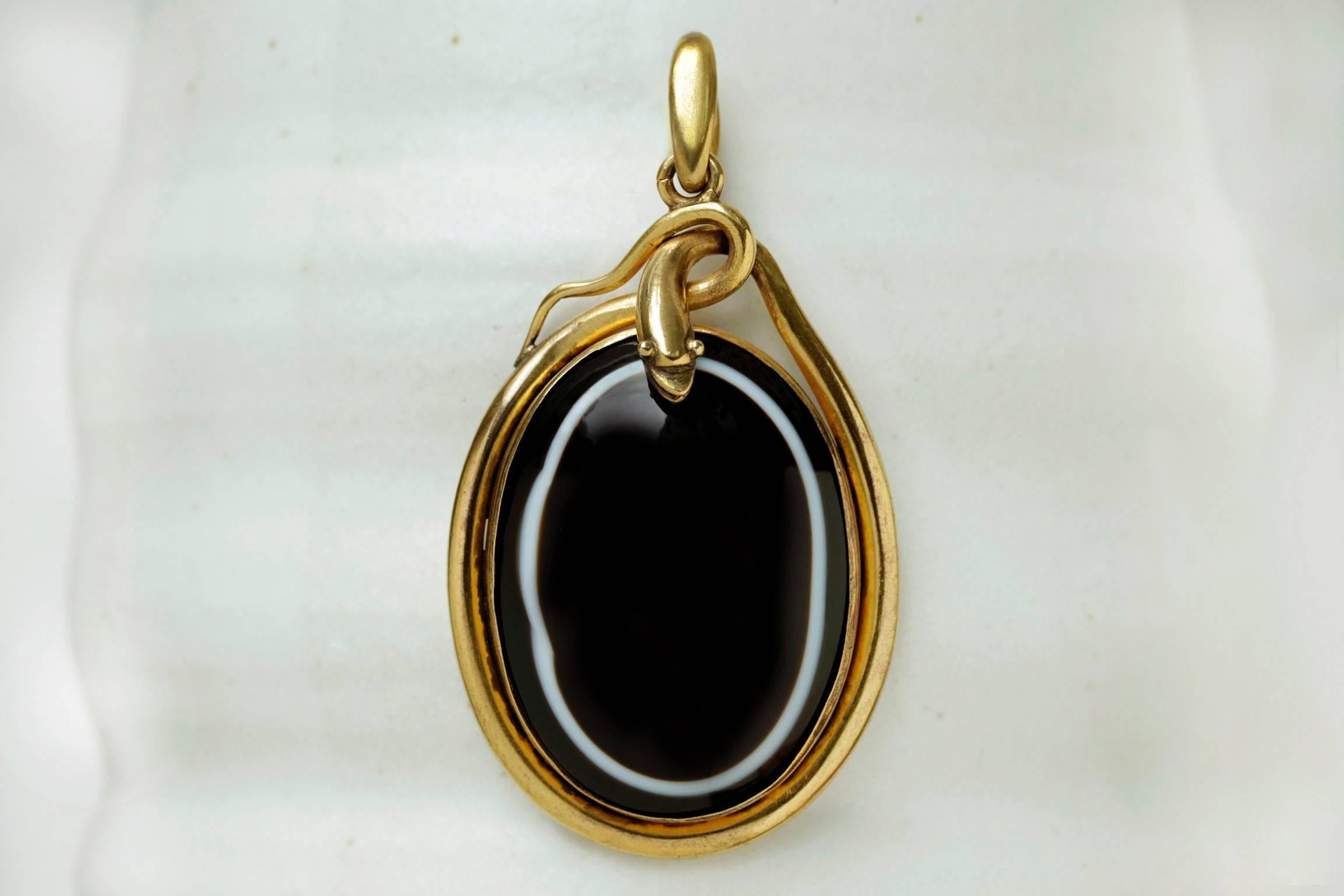 A very large Victorian banded agate snake pendant. The pendant measures approximately 2.75" h x 1.50" w. The sizable scale of the pendant provides a significantly bold and handsome appearance. It is overall in great condition without any