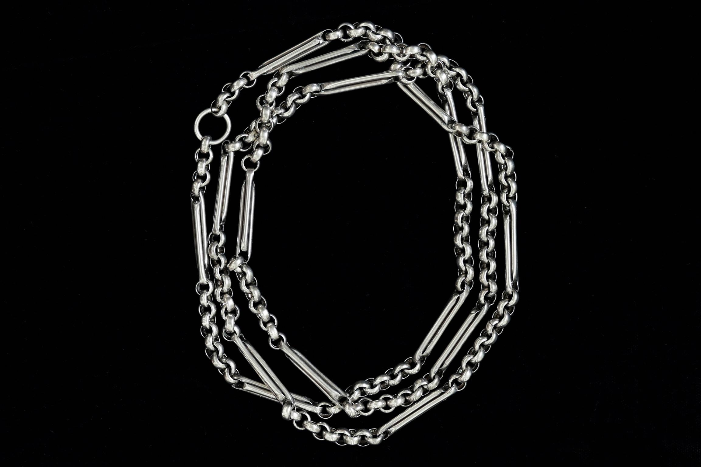 C.1880. A fabulous Victorian sterling silver watch chain. 
A rare piece with its extra length (just under 60 inches) and substantial large bars connected with chunky links. It has English standard silver hallmark on the large ring. Each bar link