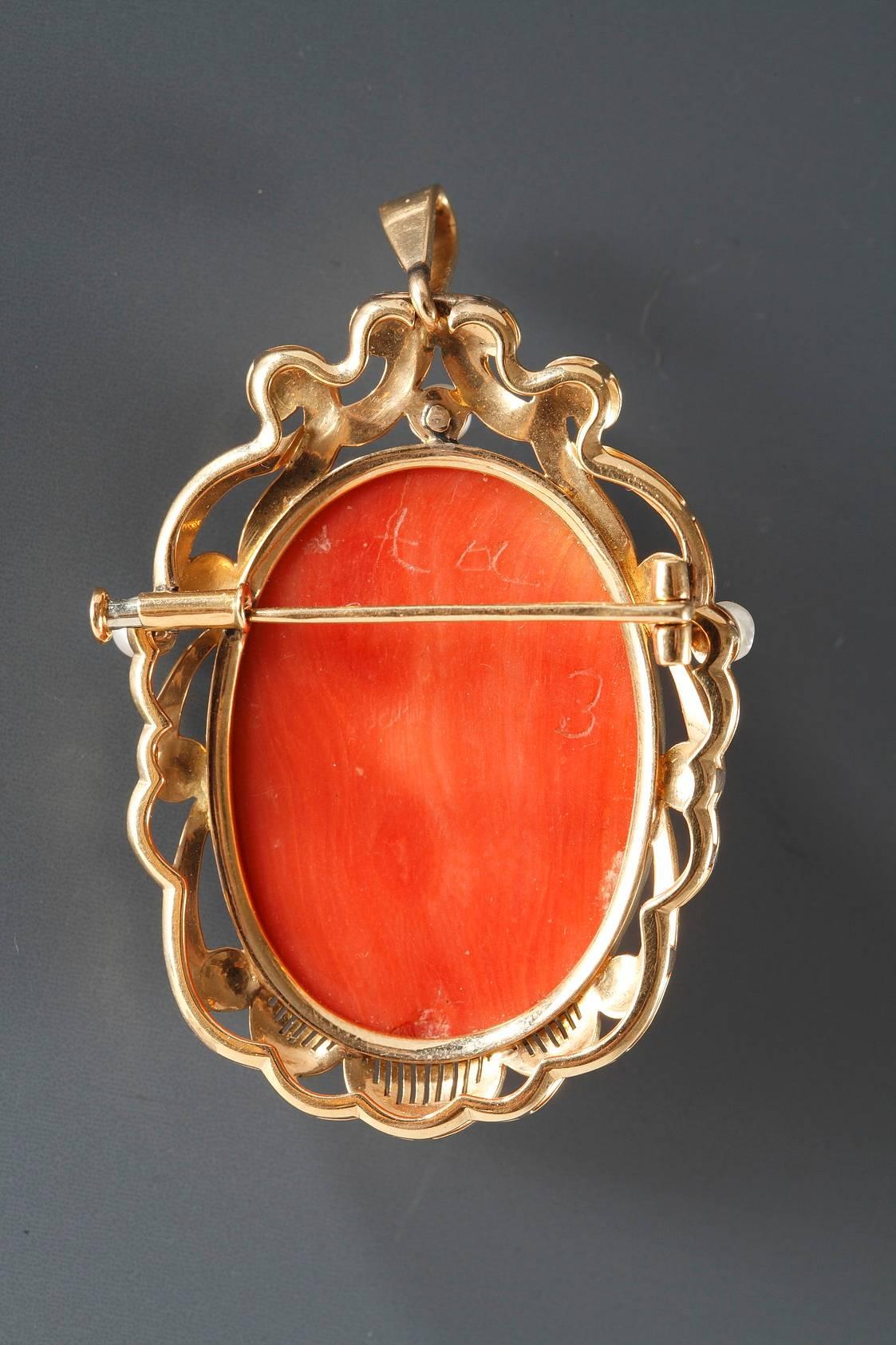 19th century oval, brooch pendant decorated with a coral cameo depicting a young woman in Renaissance taste. The mounting features gold, openwork designs and is set with three pearls. This piece of jewelry can be worn as a brooch or as a