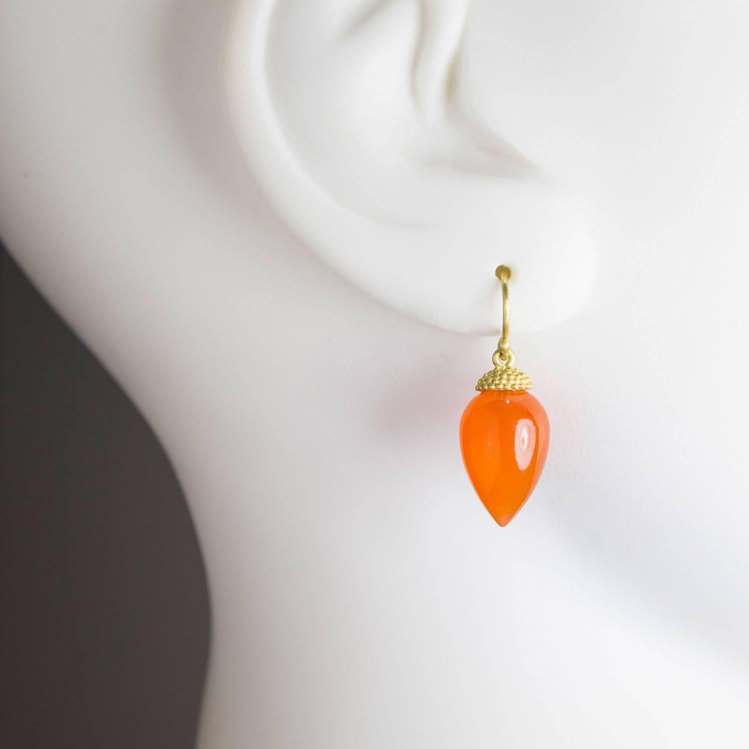Beauty in simplicity.  Add a burst of color to your wardrobe with these Acorn drop earrings in a vivid orange Carnelian.  The earrings are finished with an 18k gold granulation cap and french ear wires. 3/4 inch long