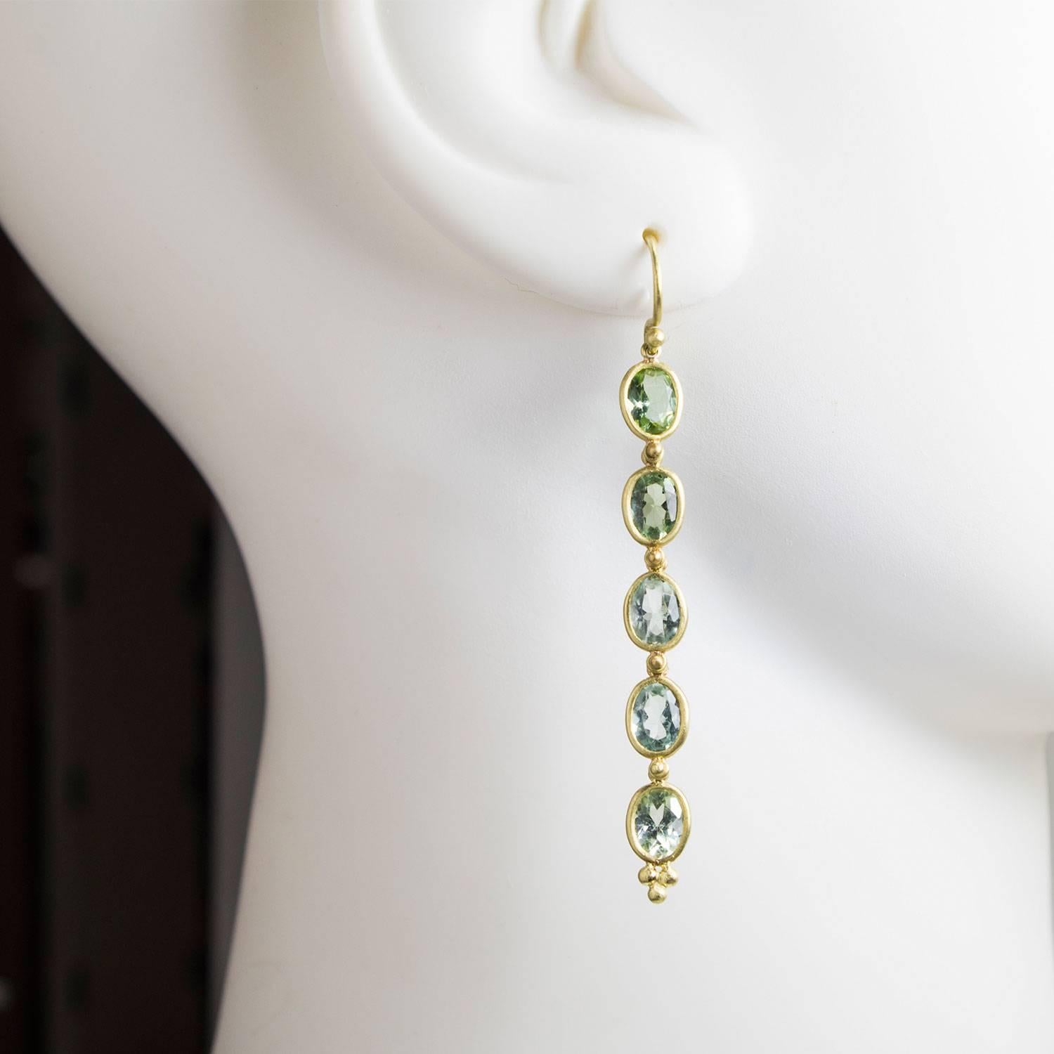 Beautiful shades of blue-green oval faceted Beryls, handcrafted in 18k green* gold are set in bezels and linked to allow movement creating a chic and elegant silhouette.  

6.50 carats twt     French Wires  2