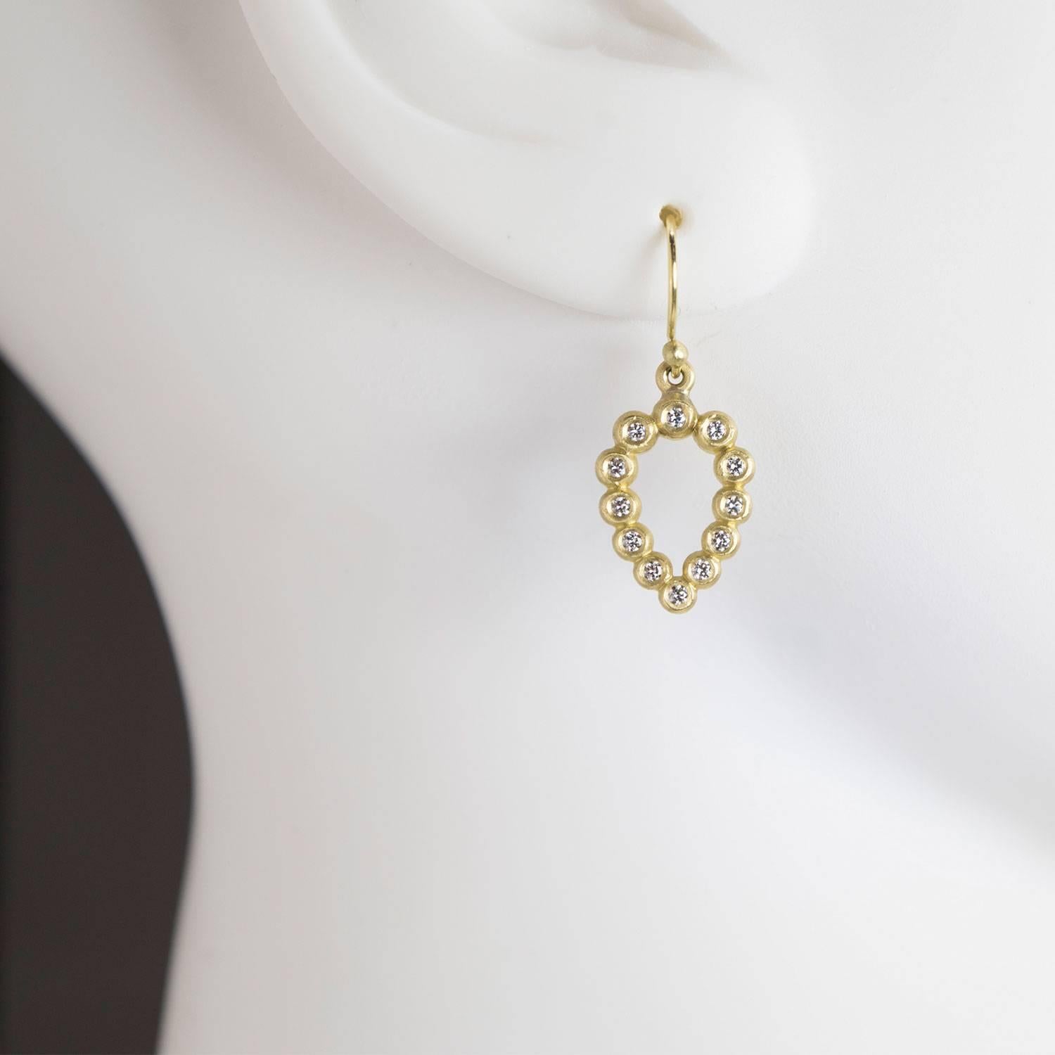 A change from the standard diamond hoops, these drop earrings have movement and are elegant enough to dress up and casual enough to wear daily.  Each 18k green* gold bead is burnished with a round brilliant cut diamond in a flattering teardrop shape