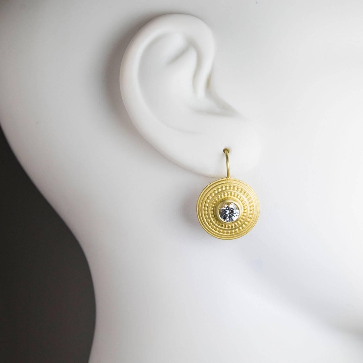 Bold and sophisticated disc earrings are crafted in 18k gold.  White sapphires add a touch of brilliance and refined elegance while the ancient granulation details accentuate the classic, timeless design.  White sapphires weigh a total of 2.30