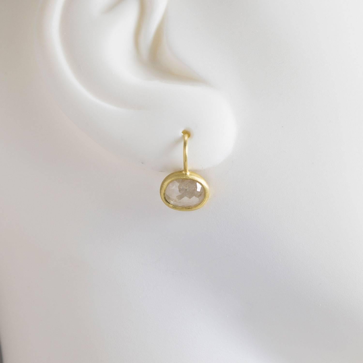 Milky diamonds set in 18k green* gold.  The simplicity of the gold bezel with ear wire make this earring so fresh and modern.  Cool, casual and distinctive, these diamond drop earrings are the perfect go to earrings!  Diamond weight is 3.13 carats. 
