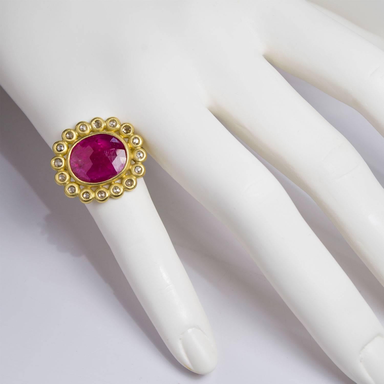 One of a kind, handcrafted ring in 18k green* gold.  Oval pink sapphire is rose cut, bezel set and surrounded by white diamond petals.  Sapphire is 4.15 carats.  Total diamond weight is .50 carats.  Width is 3/4 inch.  Size 7.  

*Faye Kim offers