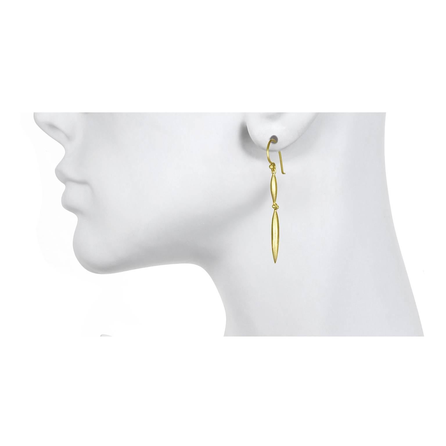 18k gold double torpedo drop earrings are sleek and sophisticated with a matte finish.  The earrings feature a granulation hinge that makes them fluid with movement when worn.  2 inch long  French ear wires

