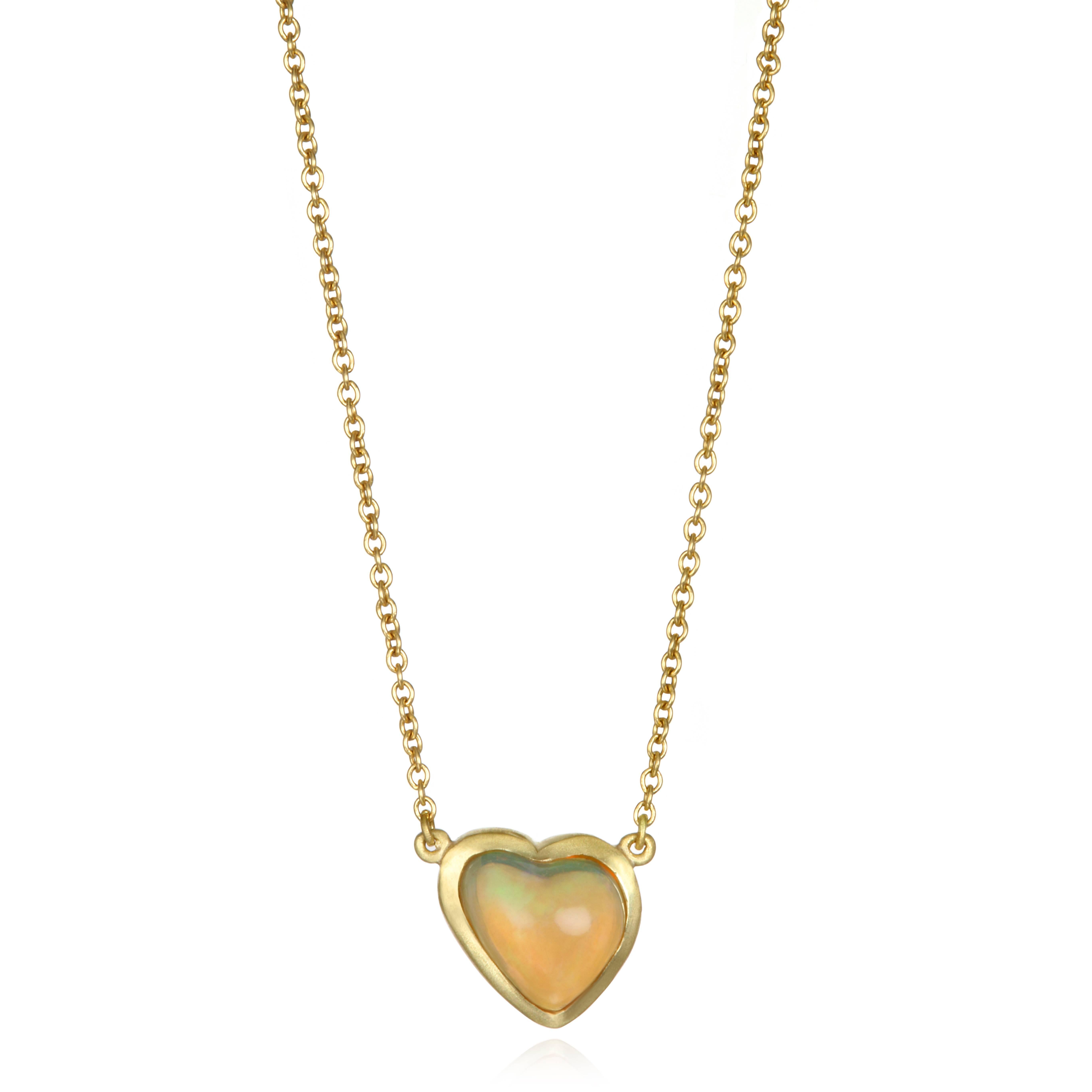Faye Kim's 18k gold necklace features a lively Mexican Opal in the shape of a heart.   Bezel set and finished on a cable link chain, the necklace is adjustable in length, 16