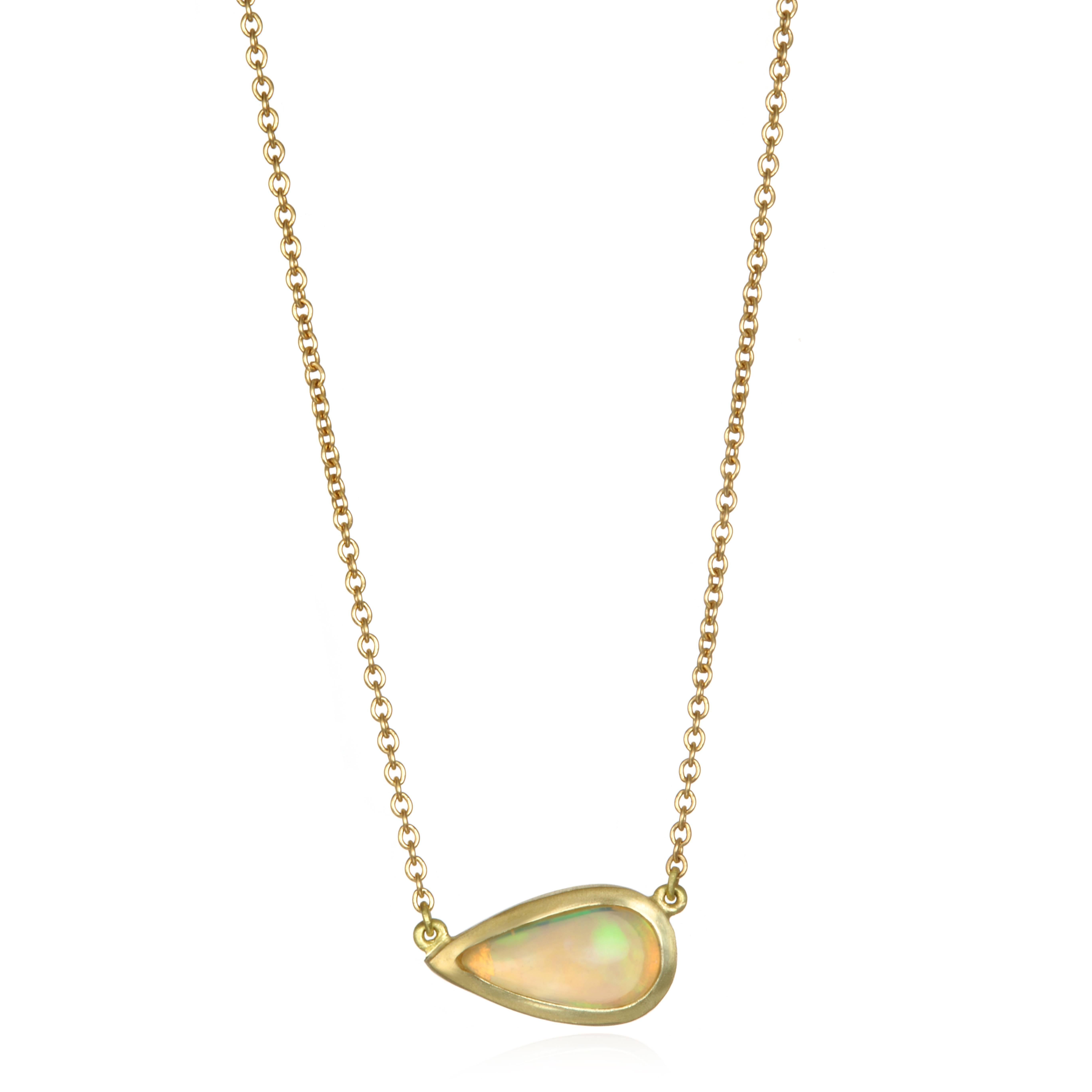 Faye Kim's 18k gold opal pendant features a teardrop shaped Ethiopian Opal on a classic cable chain, set sideways for a modern, fresh and unique style.  Adds a touch of color to any wardrobe, worn alone or add as a layering piece.

Length is