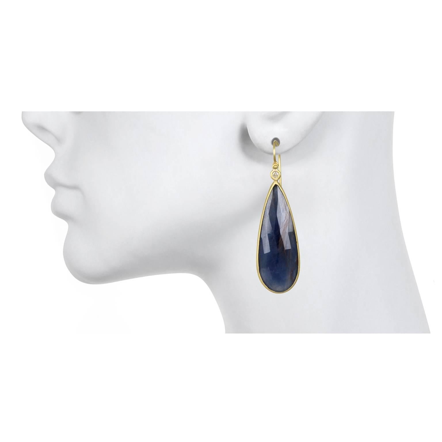 Handcrafted in 18k gold blue sapphire Tear Drop slices are bezel set and paired with bezel set round diamonds. The diamonds contrast and add a sparkle to the sapphire drop earrings. One of a kind.
Length: 1.75
