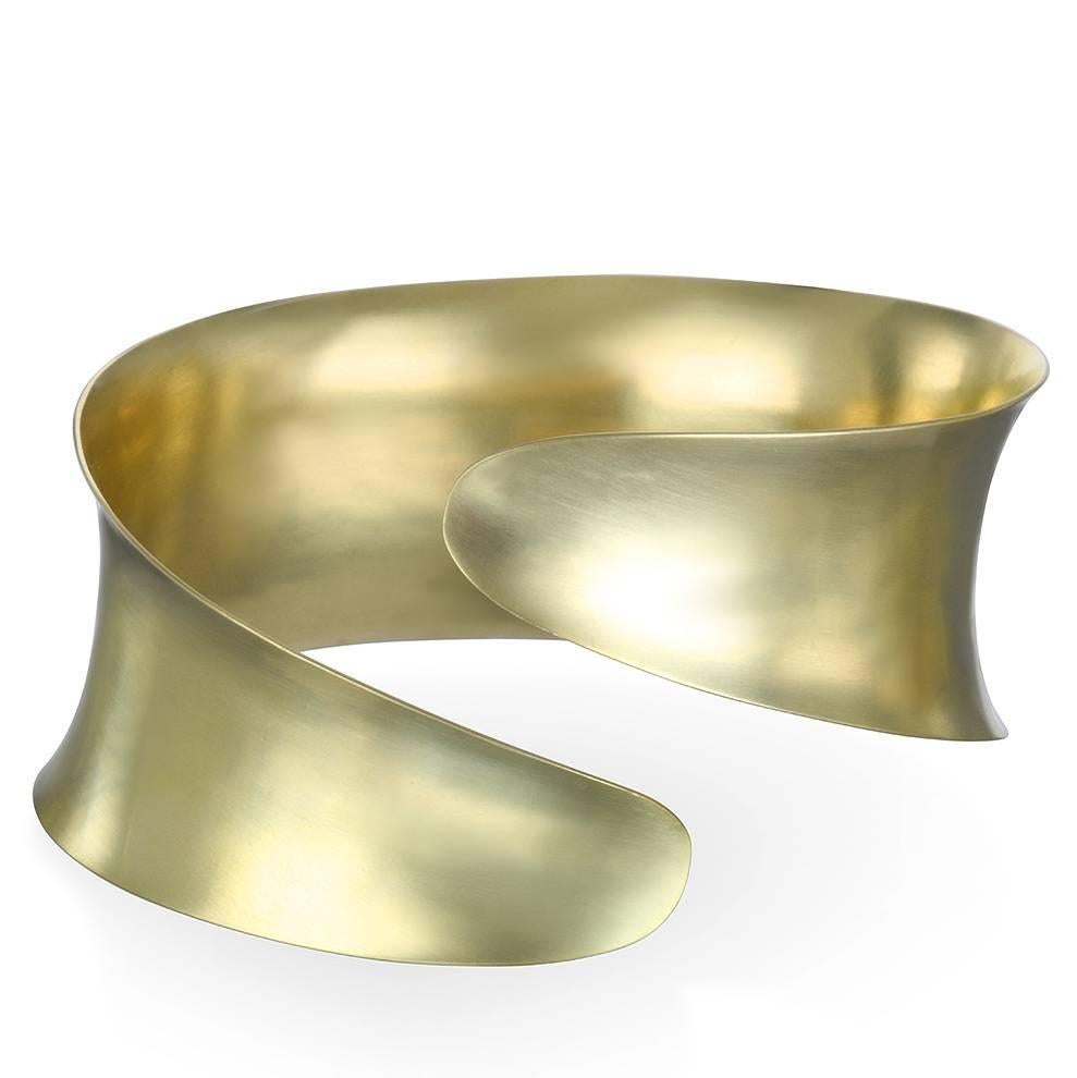 Faye Kim's Anticlastic Bypass Cuff boasts a modern design that is sure to make a statement.  Handcrafted using a technique that transforms a sheet of gold into an organic form with structural strength.
Wrap your arm in this exquisite piece of art.