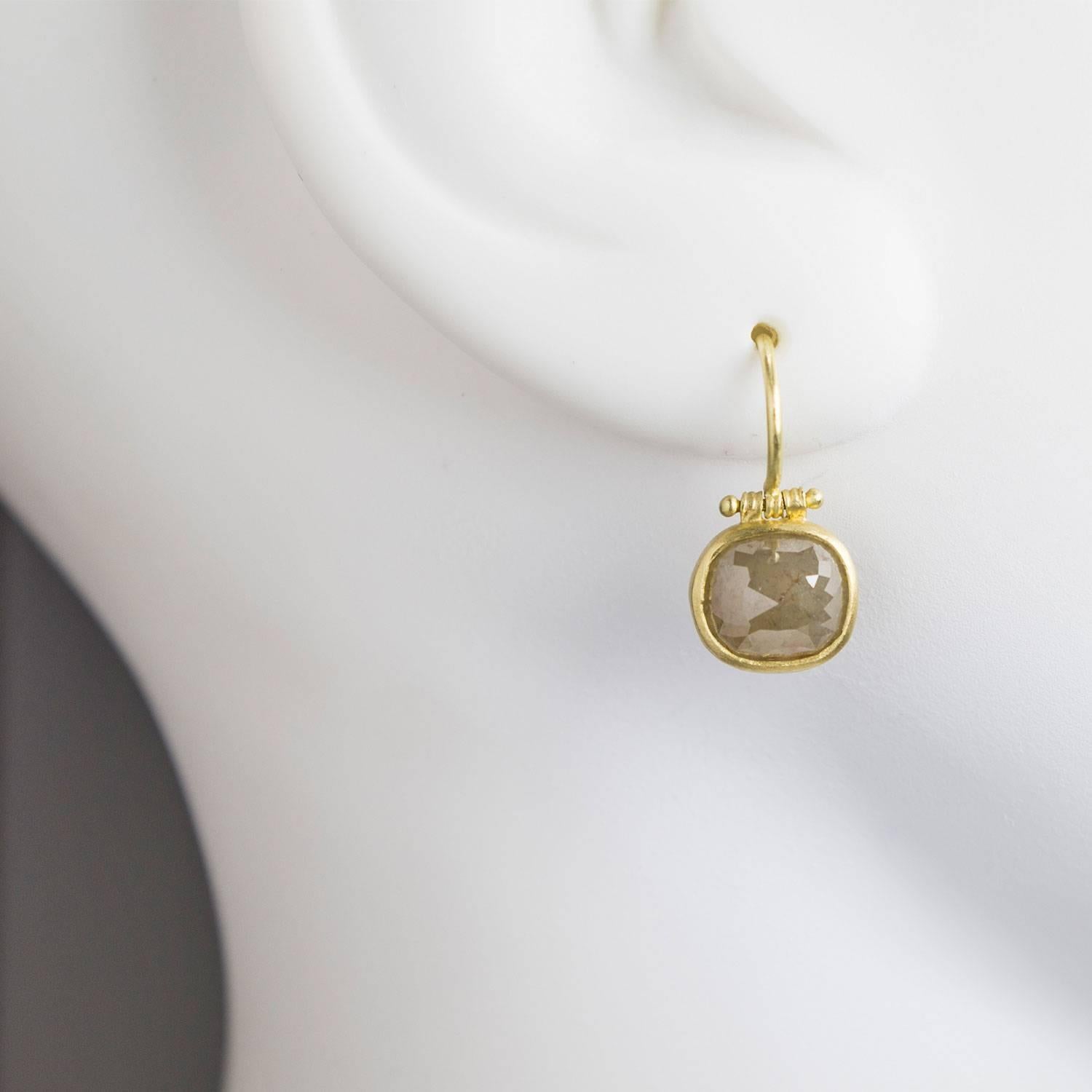 The contemporary and classic elements of this design are what makes these drop earrings essential to every jewelry collection! Handmade in 18k green* gold, cushion shaped, faceted rose cut raw diamonds are bezel set.   Granulation hinged ear wires
