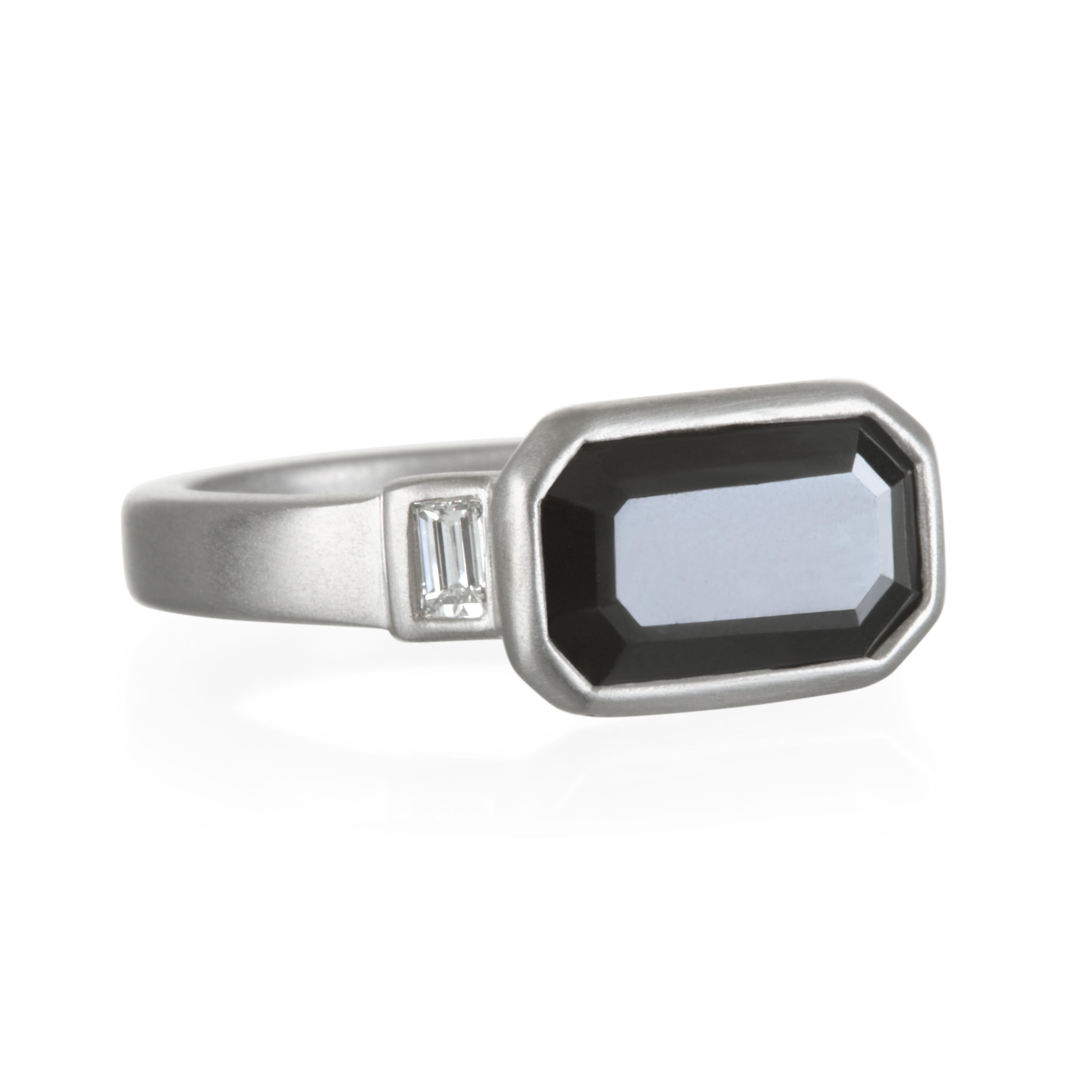 Sophistication and modern matte finish give this diamond ring its true edge and uniqueness.  From minimalist to magnificent, this ring shares the inherent power of emphasizing the spirit and individual style of its wearer.  Black diamond with side