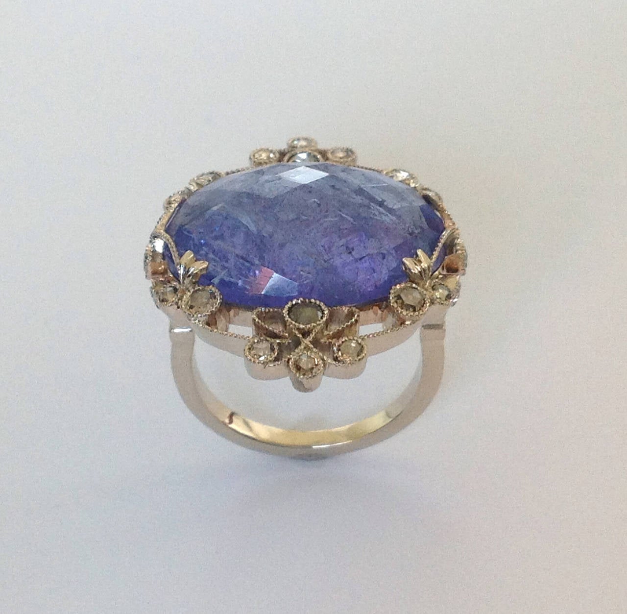 Dalben design Tanzanite And Diamond Ring mounted in 19 k white gold.
One Oval cut Tanzanite weighting 12,72 carat and 22 rose cut light brown Diamonds weighting 0,49 carats.
Ring size 7 USA - 54 EU resizable to most finger sizes. 
The Ring is