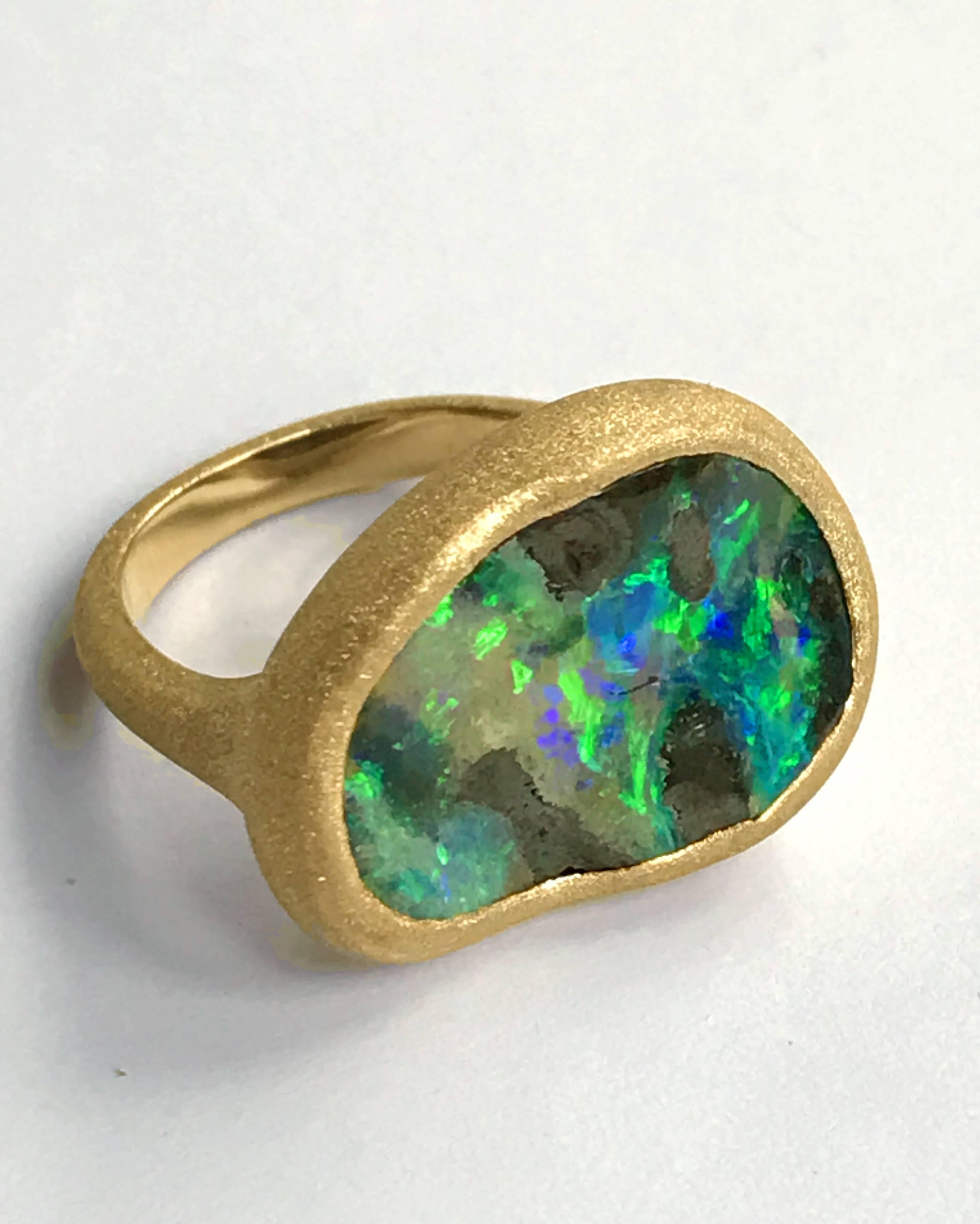 Dalben design One of a kind 18k yellow gold handmade engraved satin finishing ring with a 11,7 carat bezel-set deep Australian Boulder Opal. 
Ring size 7 1/4 - EU 55 re-sizable to most finger sizes. 
Bezel setting dimension: width 23,2 mm, height