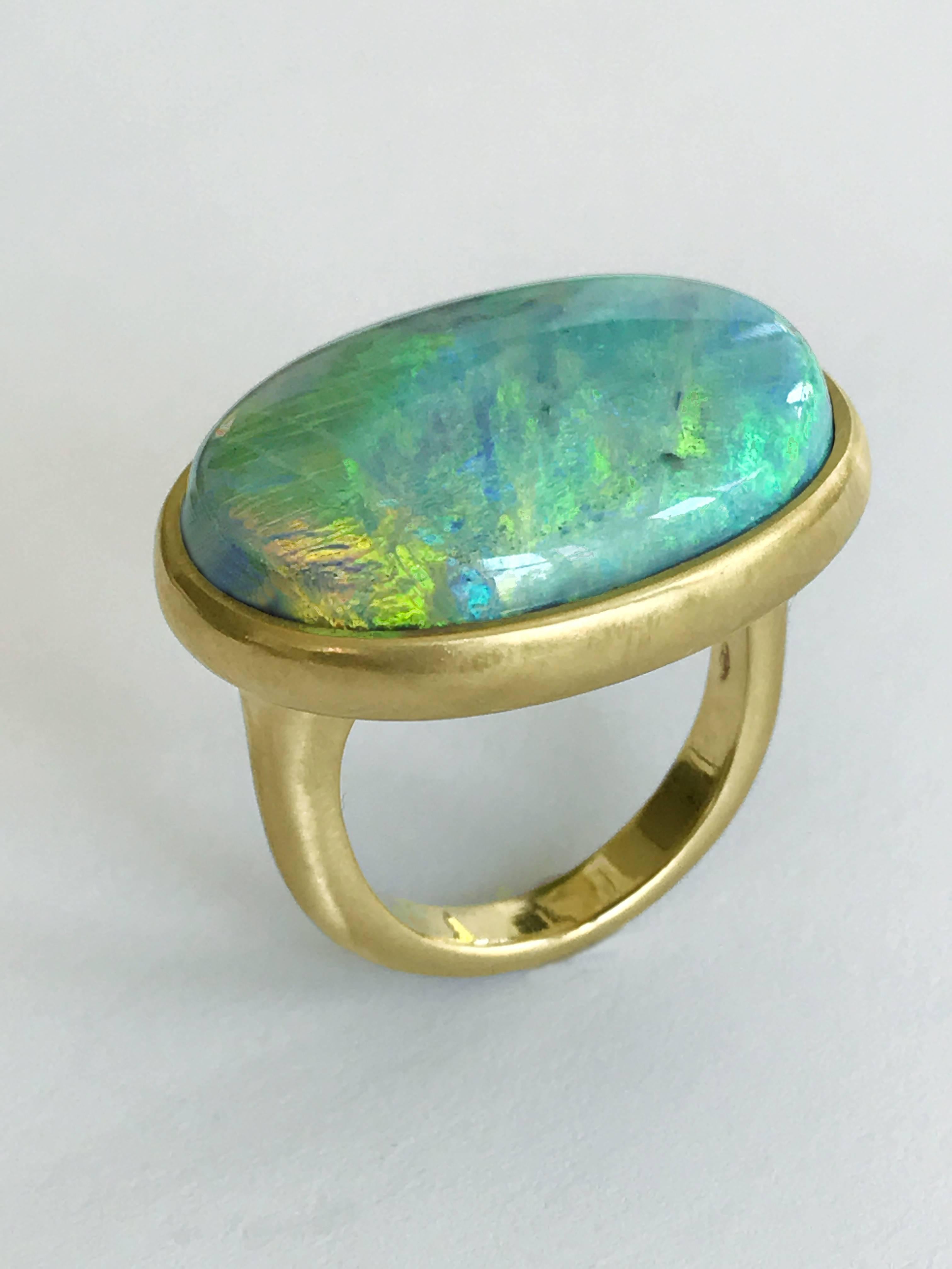 Dalben design One of a kind 18k yellow gold matte finishing ring with a 20,37 carat oval cabochon bezel-set magnificent Lightning Ridge - NSW - Australian Opal. 
This Australian Bouder Opal have wonderful light green and light blue reflex . Ring