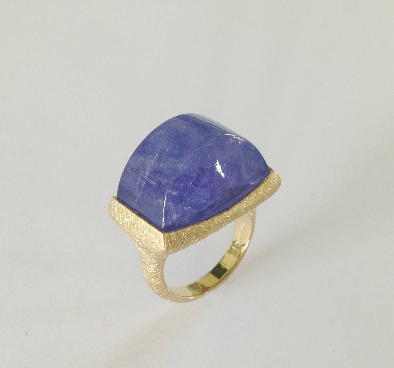 Dalben design One of a Kind 18k yellow gold scratch handmade finishing ring with a 44 carat bezel-set cabochon Tanzanite.

Ring size 7 1/4 - EU 55 re-sizable to most finger sizes.

The ring is completely hand made in our atelier in Italy Como