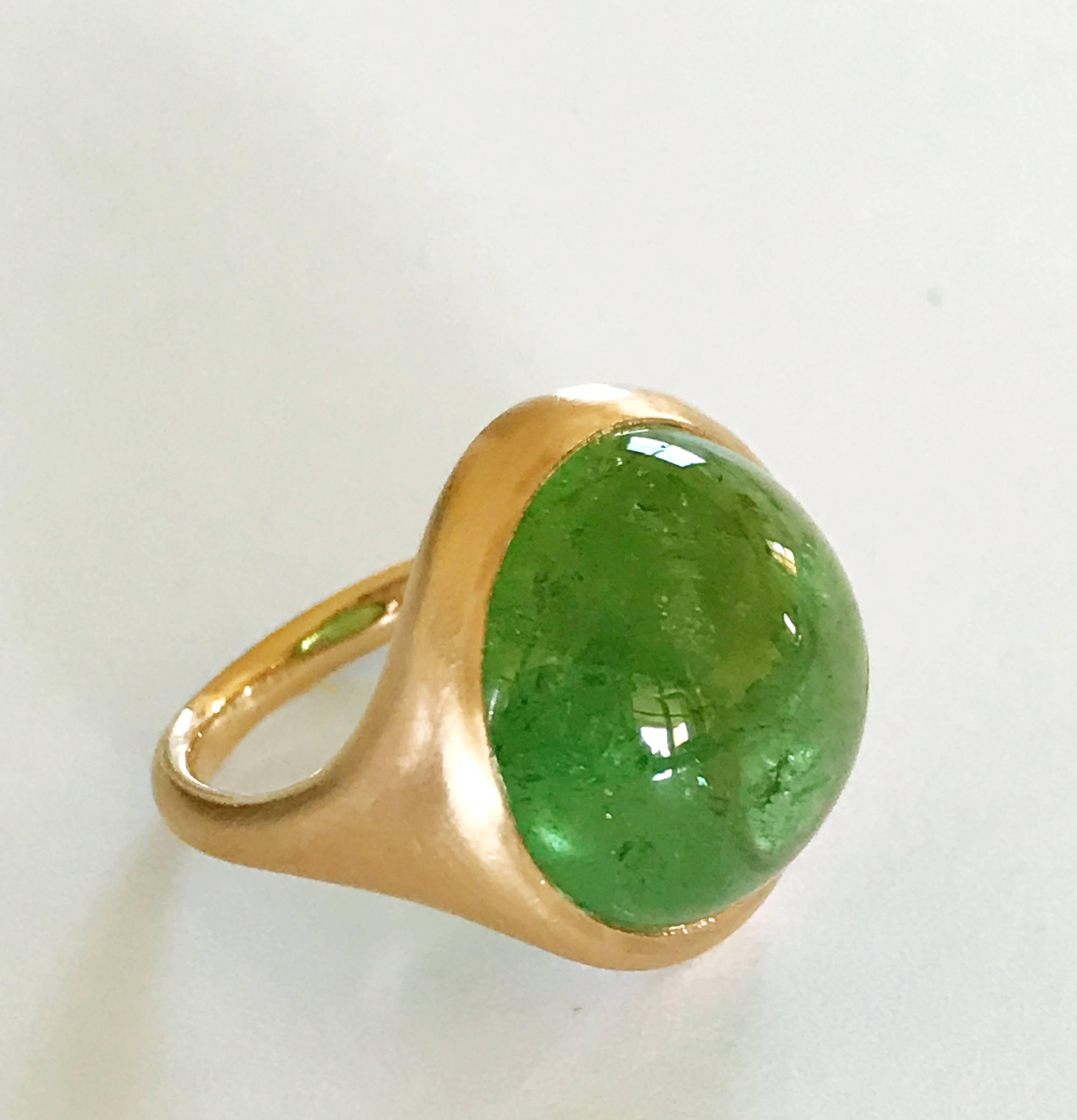 One of a Kind 18k rose gold matte finishing ring with a 18,1 carat bezel-set round cabochon cut Green Tourmaline.  
Ring size 7 1/4 - EU 55 re-sizable to most finger sizes.  
Bezel stone dimensions : width 19,5 mm height 19,5 mm.
The ring is