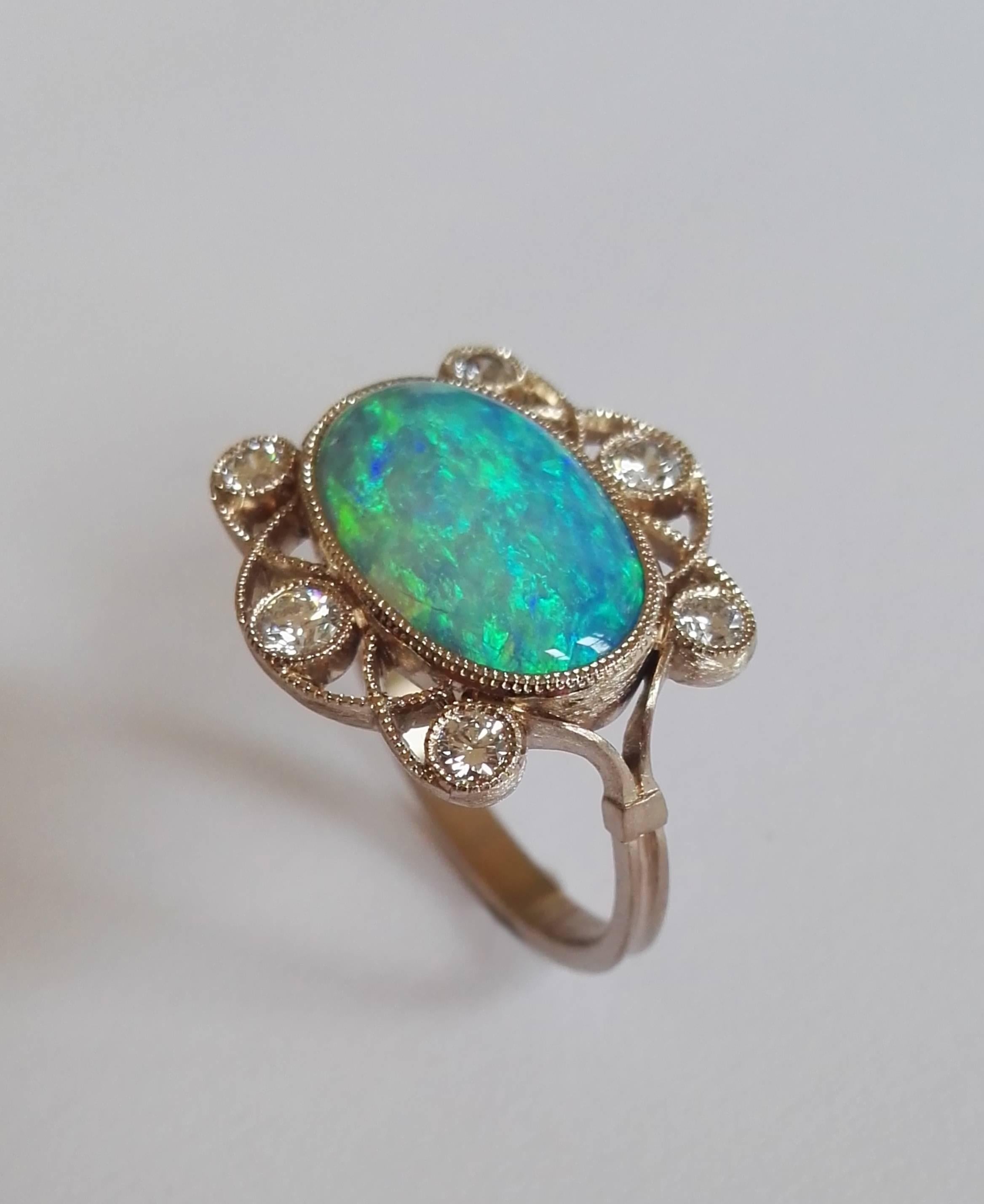 Dalben design Opal ring with an Australian Opal weight 2,36 carat and 6 white round brillant cut Diamonds total weight 0,36 carats mounted in 18 kt  satin finishing warm white gold. 
Ring size 7 1/4 USA - 55 EU .  
Bezel setting dimension:
max width