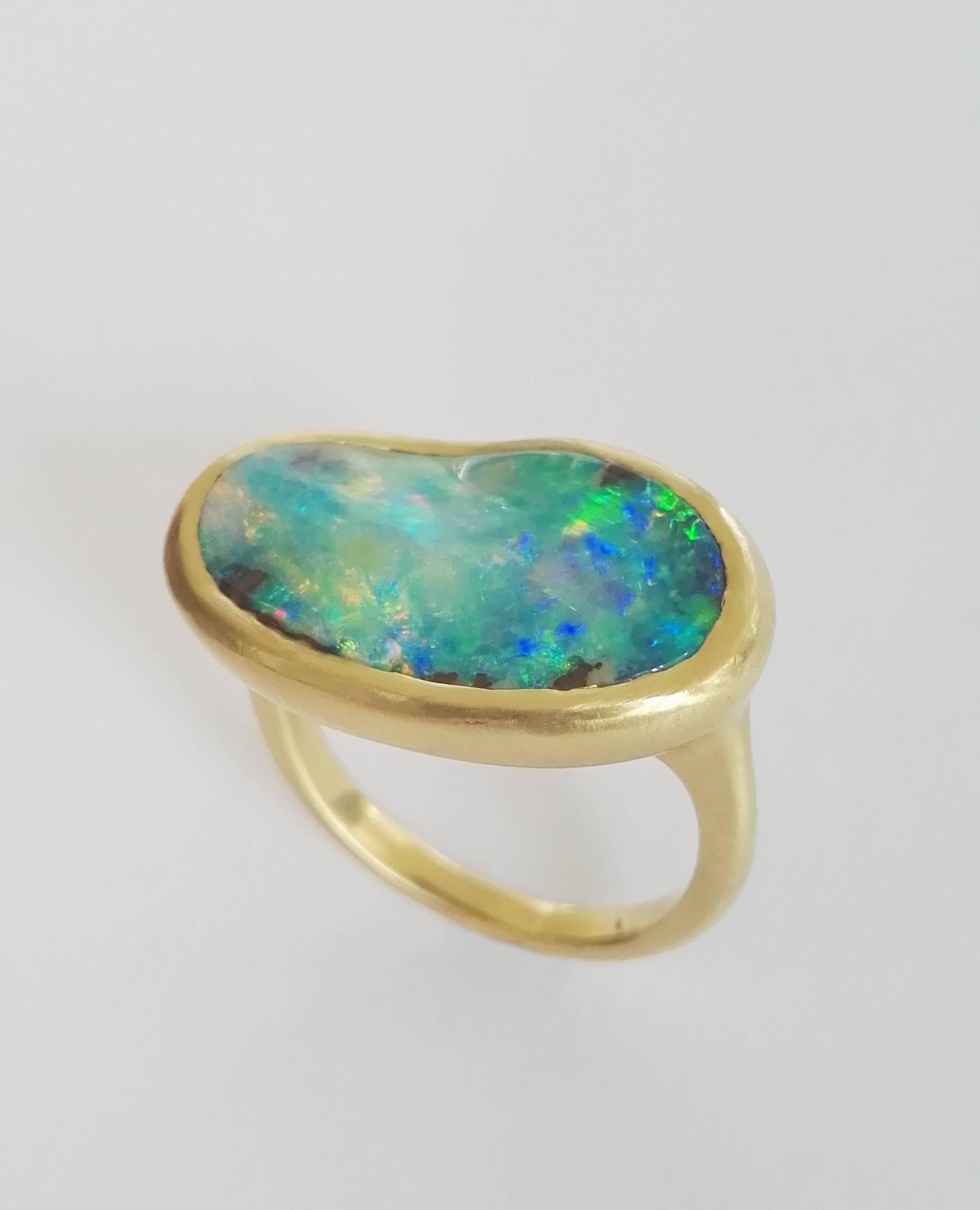 Dalben design One of a kind 18k yellow gold matte finishing ring with a 7,18 carat bezel-set magnificent Boulder Opal.
This Australian Bouder Opal seems the Sardinia sea.
Ring size 7 1/4 - EU 55 re-sizable to most finger sizes.
bezel setting