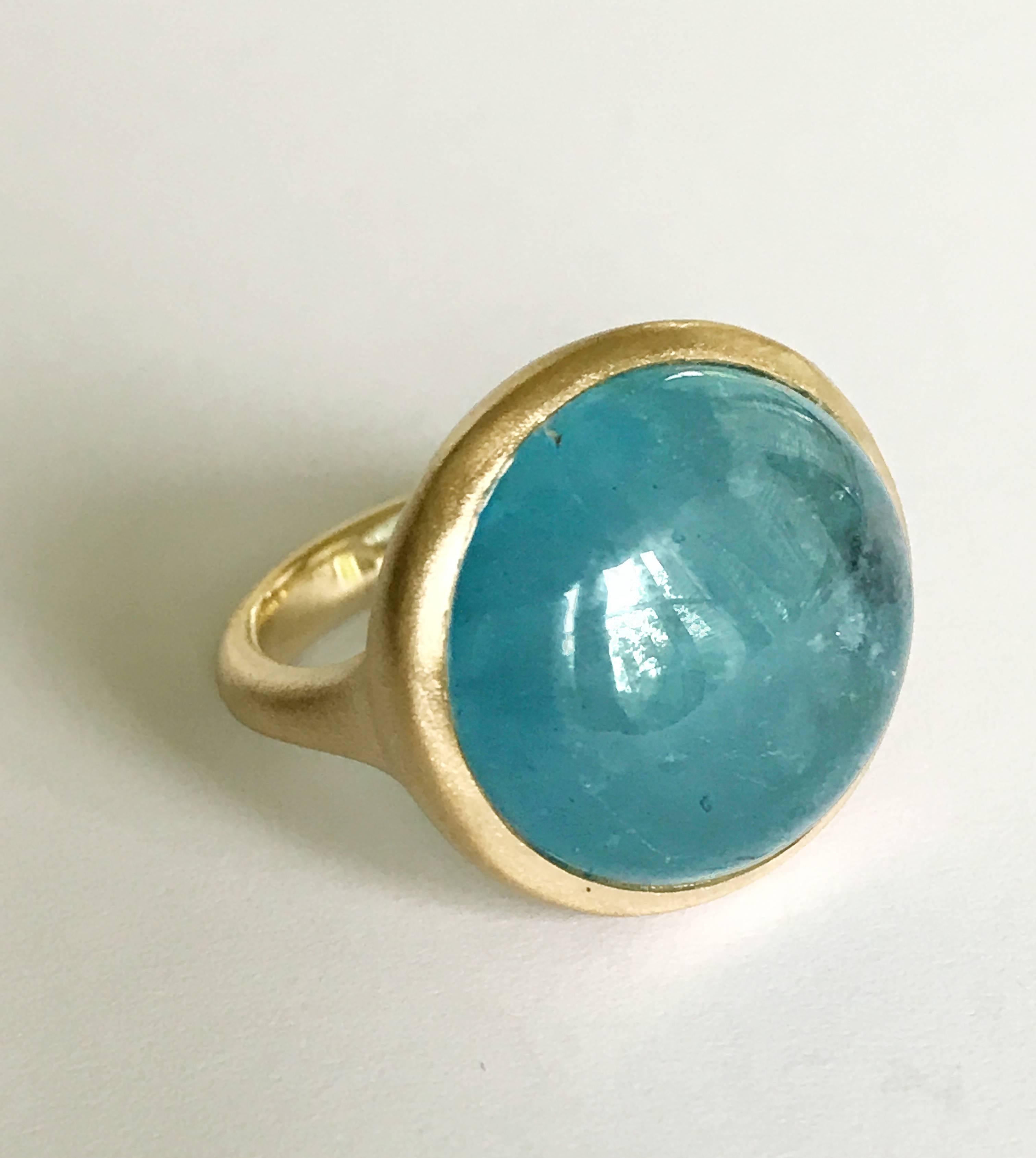Dalben design One of a Kind 18k yellow gold matte finishing ring with a slightly foggy 21,5 carat bezel-set round cabochon cut Aquamarine.  
Ring size 6 3/4 - EU 54 re-sizable to most finger sizes.  
Bezel stone dimensions :  width 21 mm  height