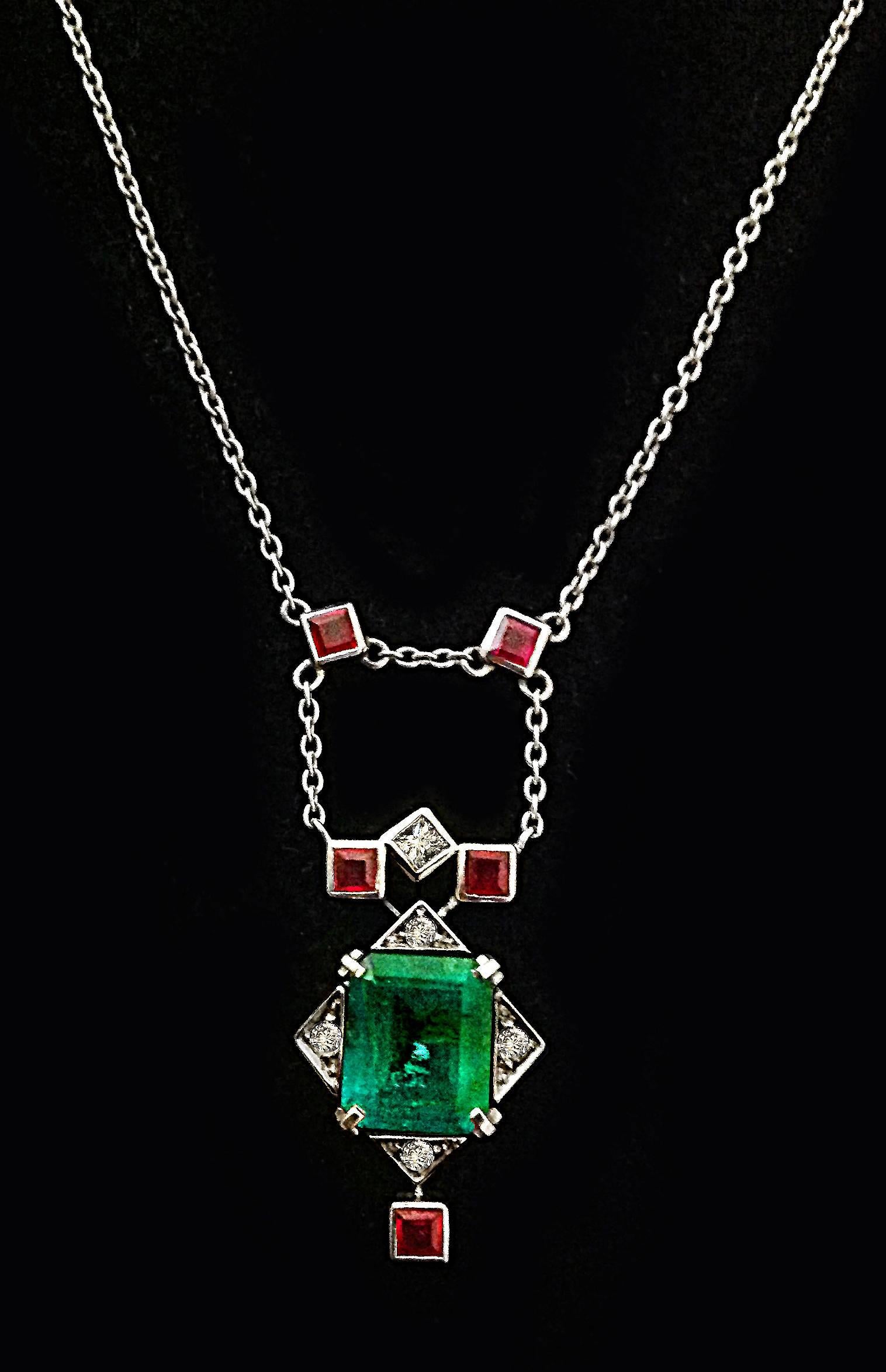 Dalben design 2,38 carat emerald monted in 18 kt white gold pendant necklace.
The emerald is surrounded by diamonds ct. 0,18 circa and ruby 0,25 ct. circa.
Pendant dimension:
width 11,7 mm 
height 21,7 mm
Chain length 42 mm resizable
The necklace