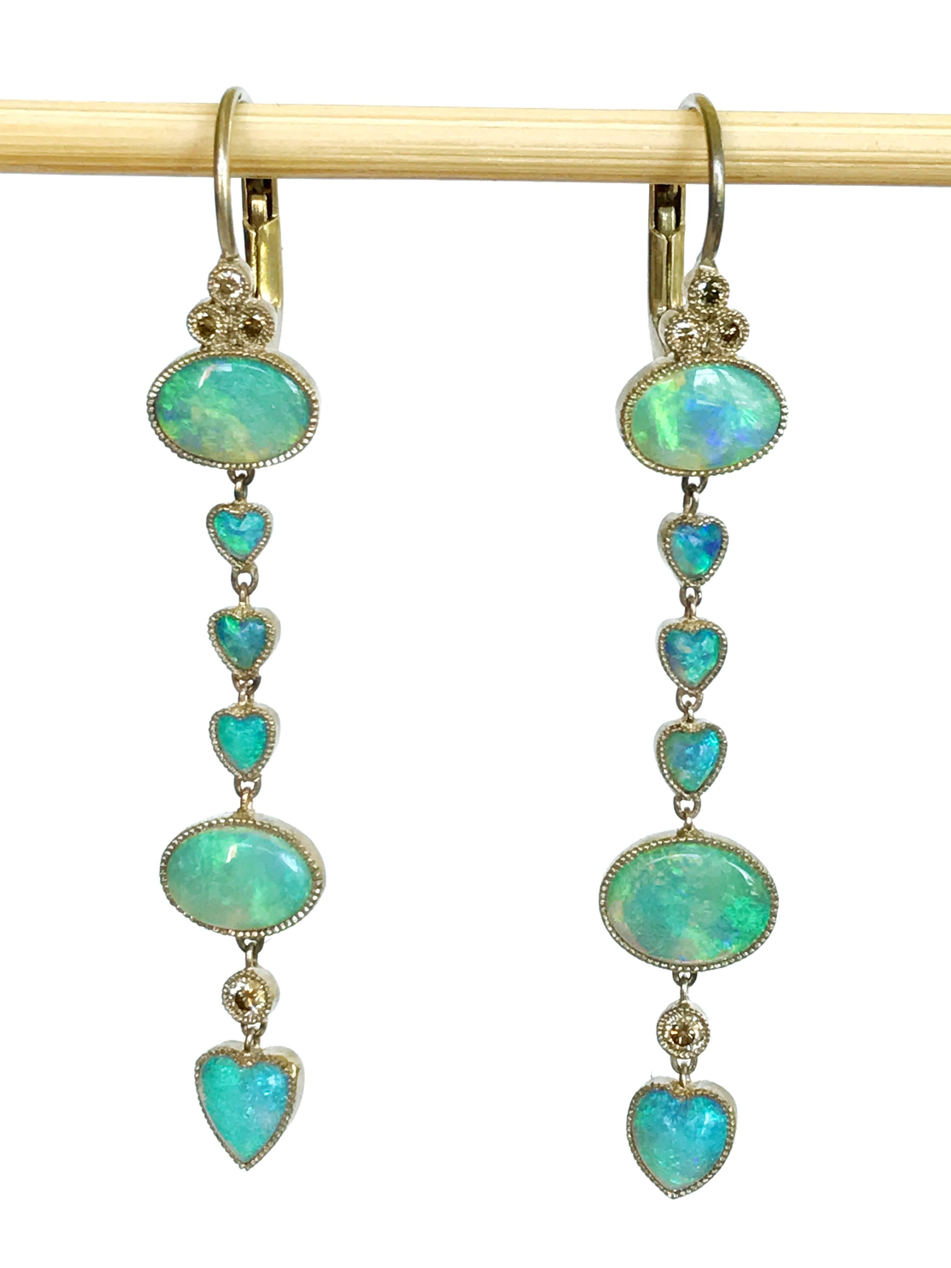 Dalben design Opal drop earrings with oval and heart shape green-azure Australian Opals and 12 brown round brillant cut Diamonds weighing 0,12 carats mounted in 18 kt warm white gold. 
Dimension: width 7,5 mm height without leverback 42 mm 
The