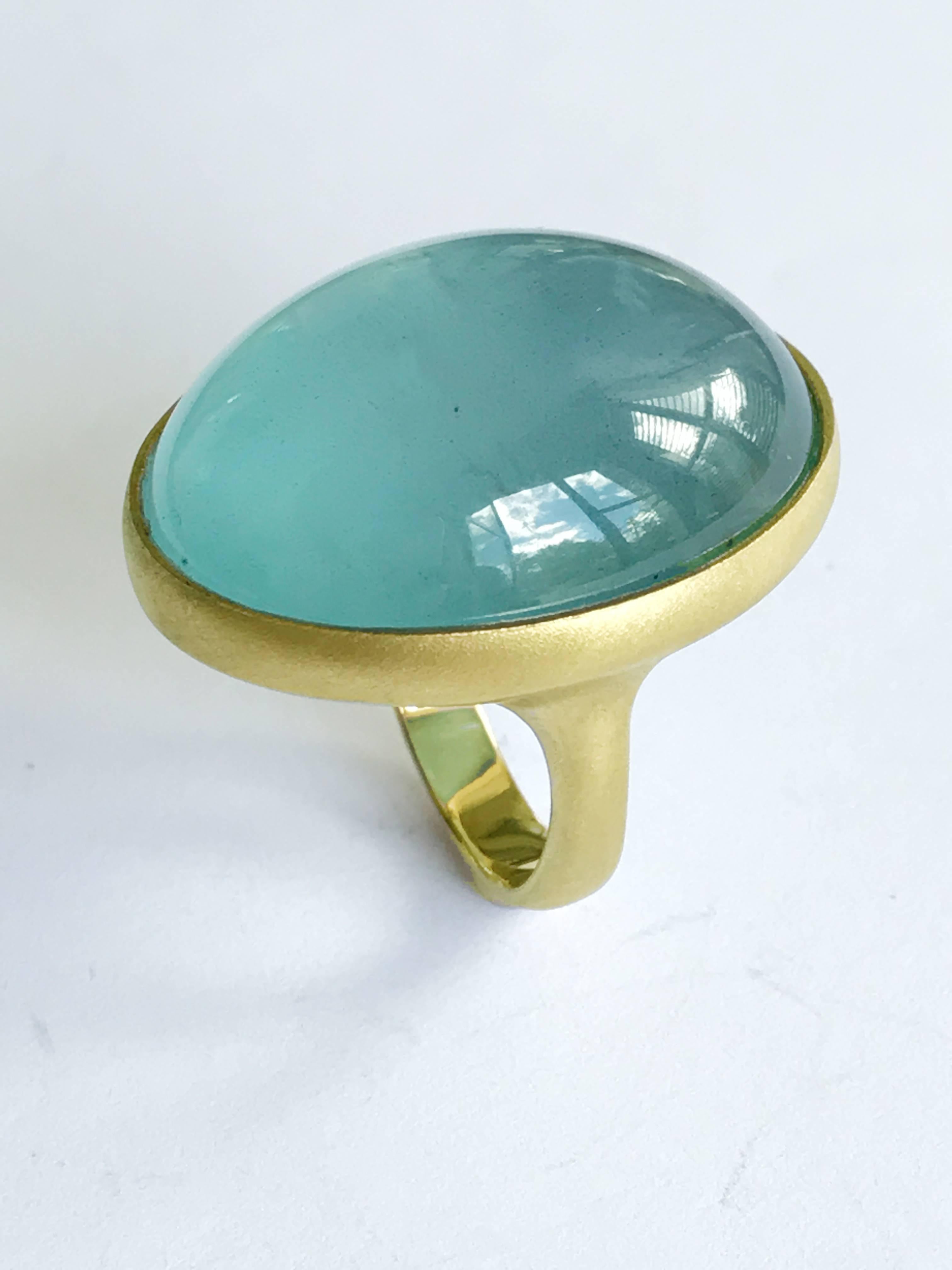 Dalben design One of a Kind 18k yellow gold matte finishing ring with a magnificent slightly foggy 62 carat bezel-set cabochon cut Aquamarine.  
Ring size 7 1/2 - EU 56 re-sizable to most finger sizes.  
Bezel stone dimensions :  
width 25,2 mm 