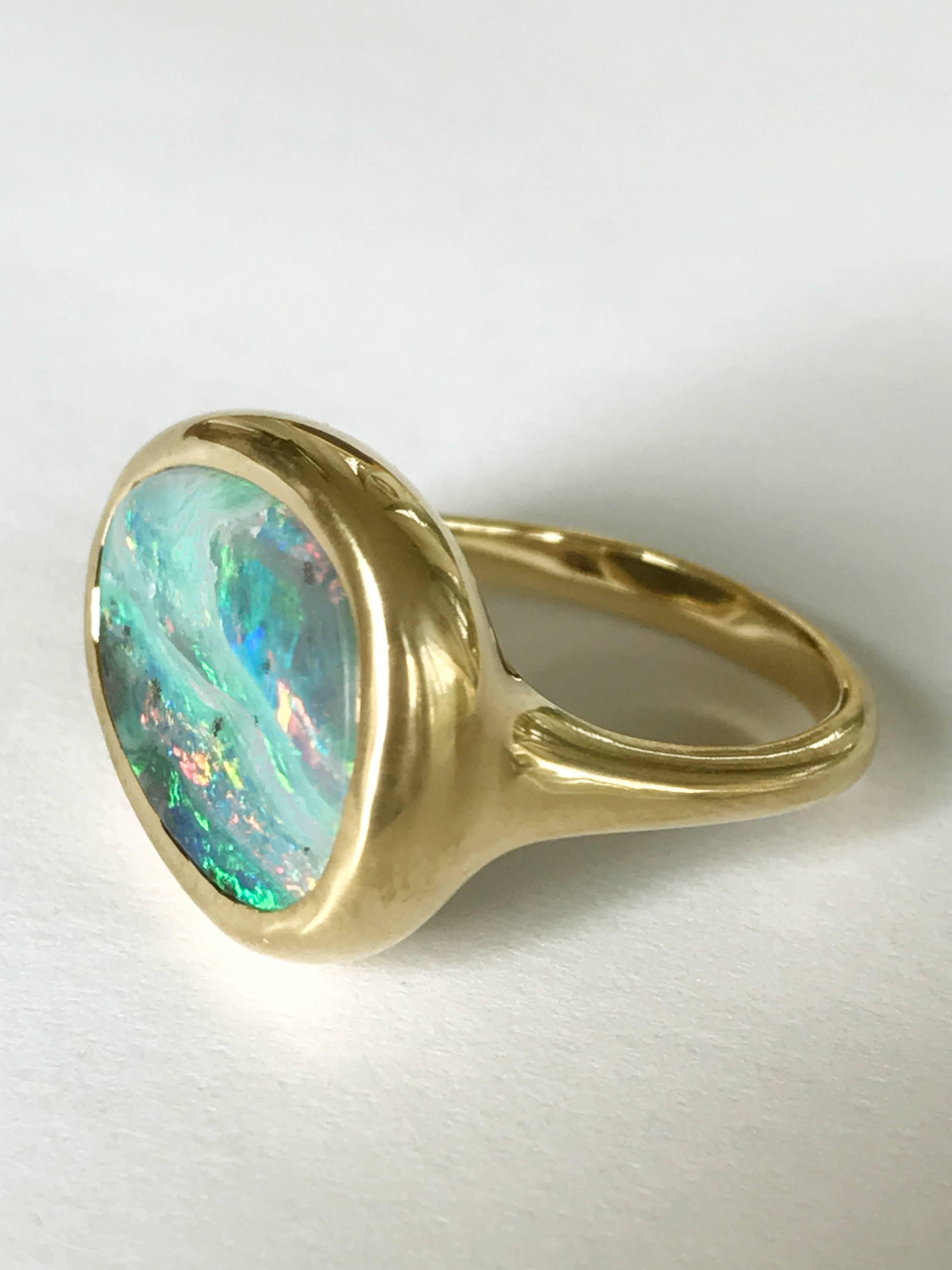 Dalben design One of a kind 18k yellow gold semi lucid finishing ring with a 6,7 carat bezel-set lovely Australian Boulder Opal .  
The stone colors looks like a Stormy sky on the sea. .  
Ring size 6 3/4 - EU 54 re-sizable to most finger sizes. 