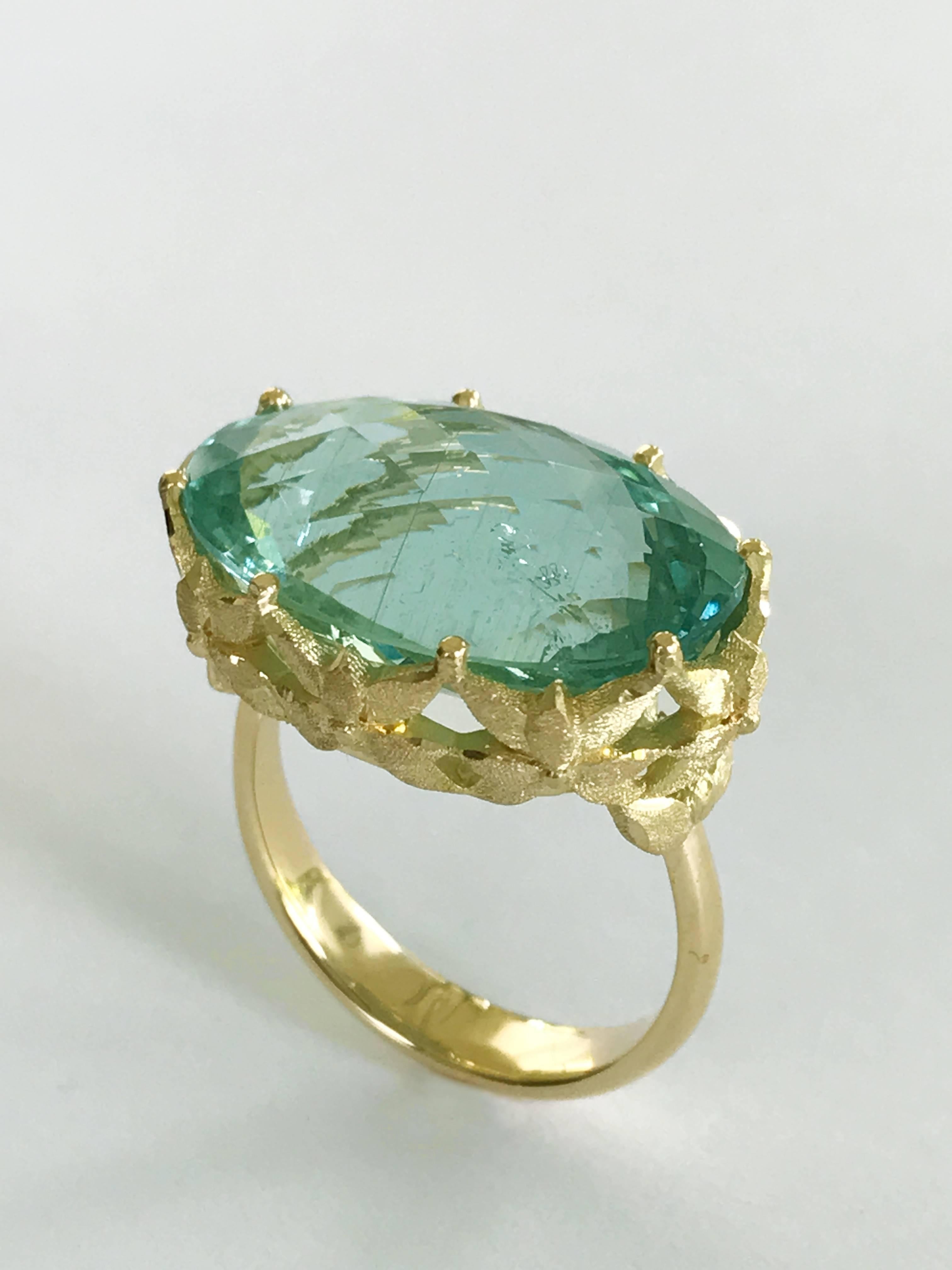 Dalben design 18 kt engraved yellow gold Cocktail Ring with an Oval cut  Aquamarine weighting 13,40 carat .  
Ring size 6 3/4 USA - 54 EU resizable to most finger sizes.  
Bezel setting dimension: 
width 22,5 mm, height 15,2 mm.  
The Ring has been