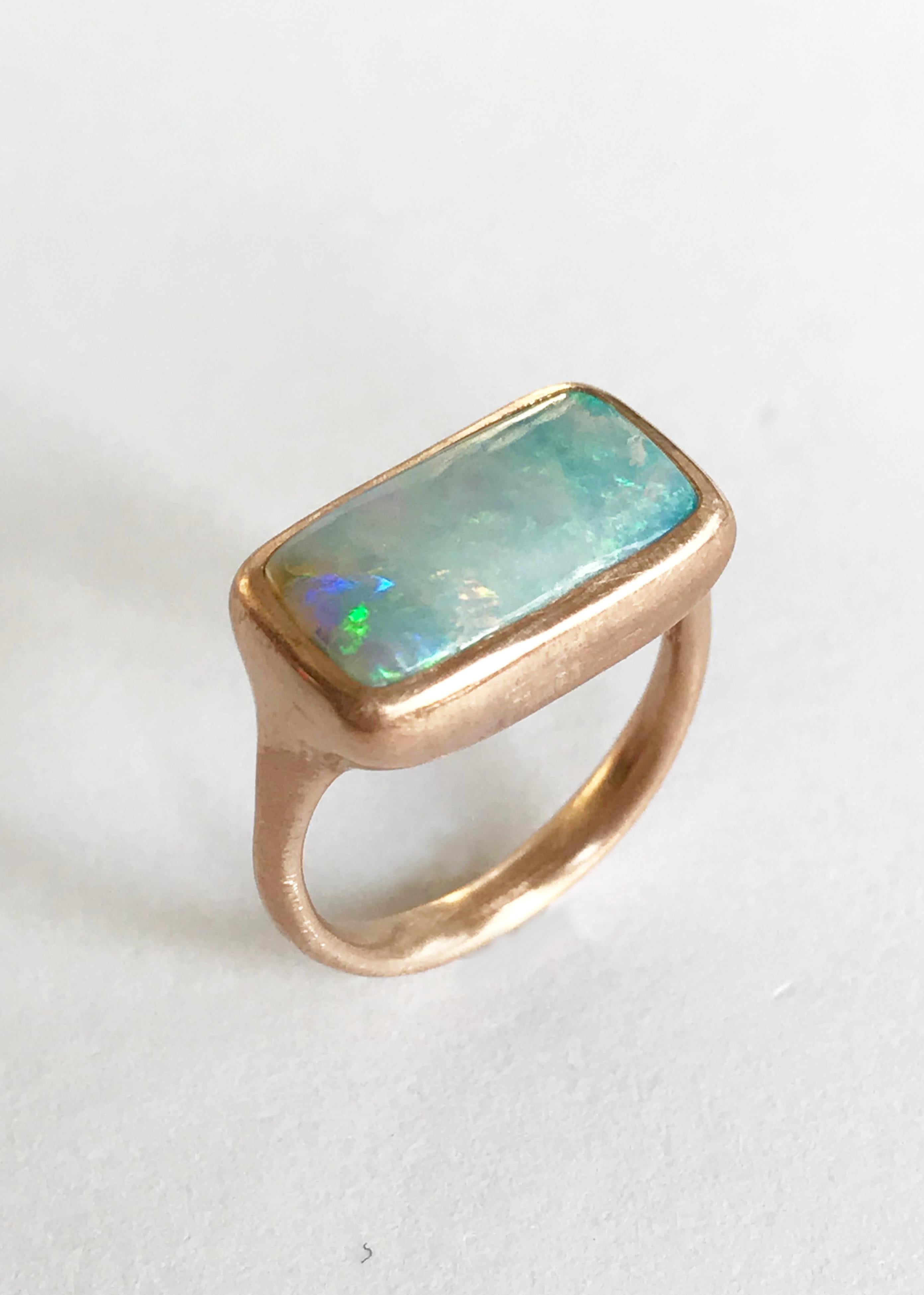 Dalben design One of a kind 18 kt rose gold matte finishing ring with a 4,05 carat bezel-set rectangular Australian Boulder Opal .  
The stone has light blue pastel colors with green light spots.
Ring size 6 1/4 - EU 52 re-sizable to most finger
