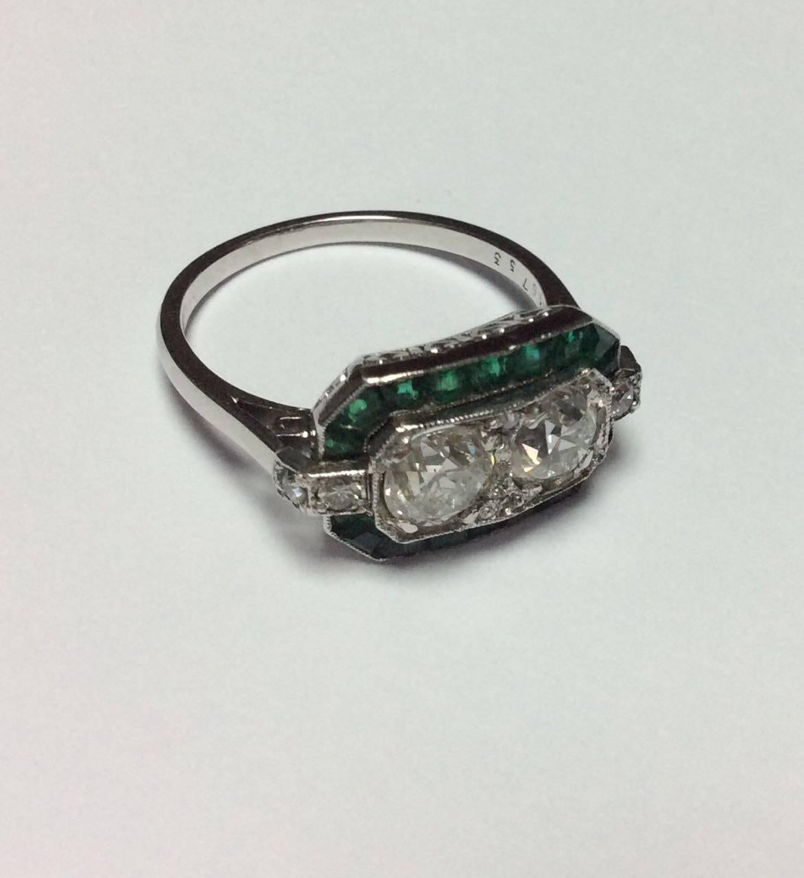 1910s Art Deco platinum Ring set with two diamonds brillant cut. Total diamonds weight estimated at approximately 1.30 cts with calibré emerald. French work circa 1910.