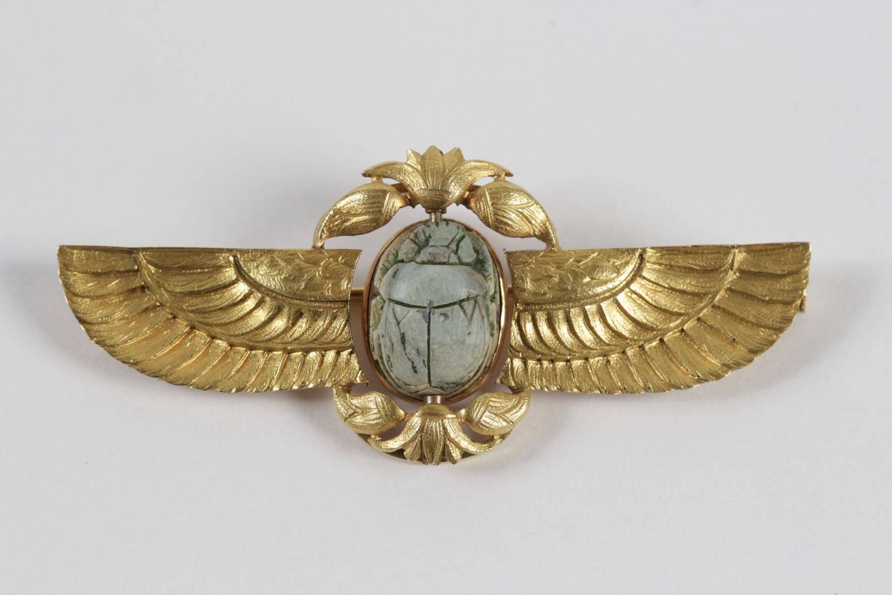 Egyptian revival 18k yellow  gold brooch set with a green stone scarab.