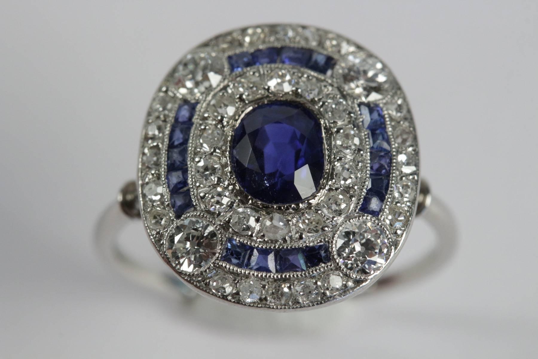 Belle Epoque platinum ring set in the center with natural Burma oval sapphire (no indications of modification or treatment) approximate weight 1.10 carat surrounded with brillant cut diamonds for an approximate total weight of 2.50 carats. Circa