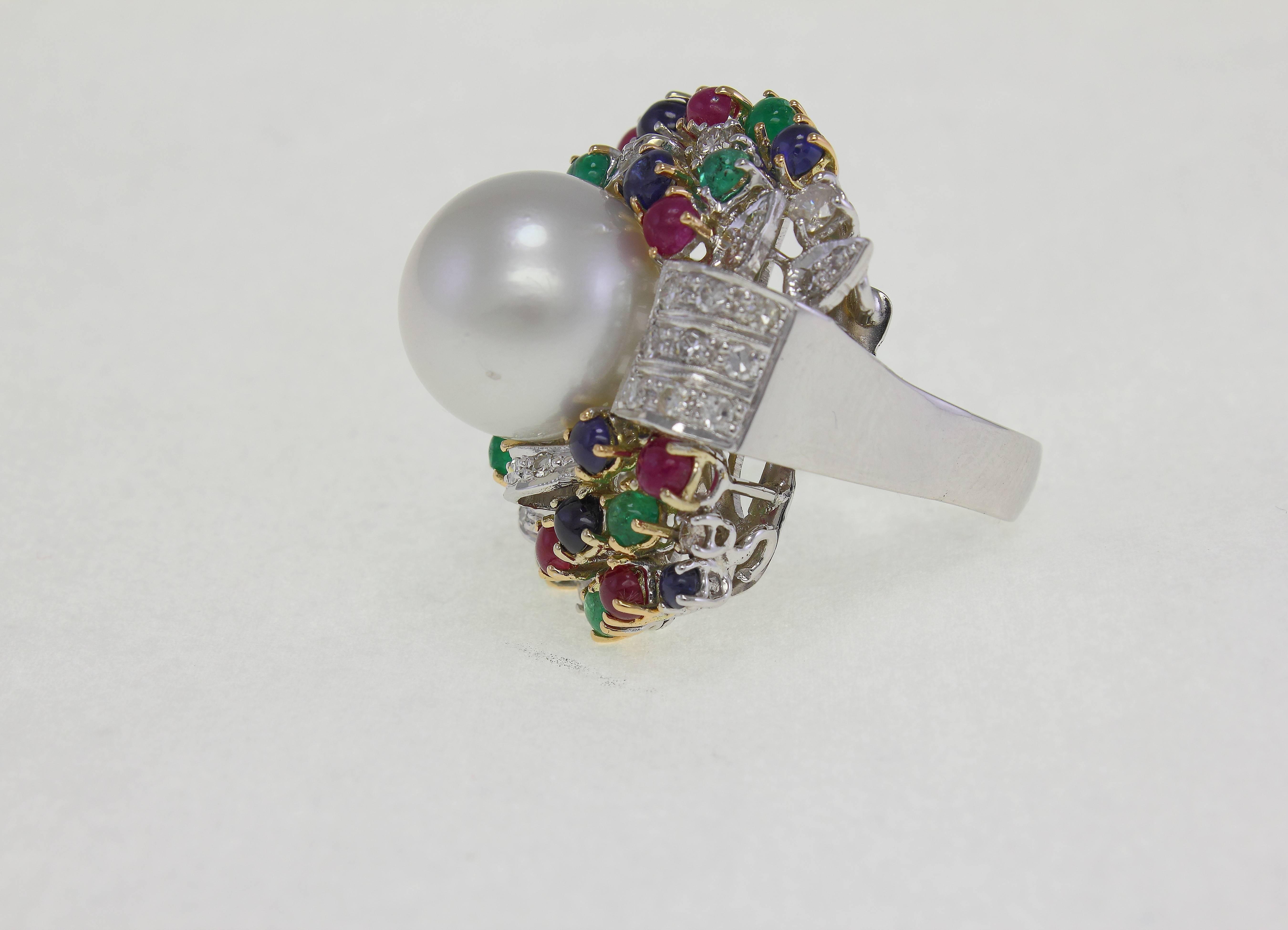 14 carat white gold ring in US size 8.5 / EU size 17, with a pearl of 15mm diameter / 0.59 inch, surrounded by diamonds (1.39 carat), sapphires, rubies & emeralds (5.82 carat).