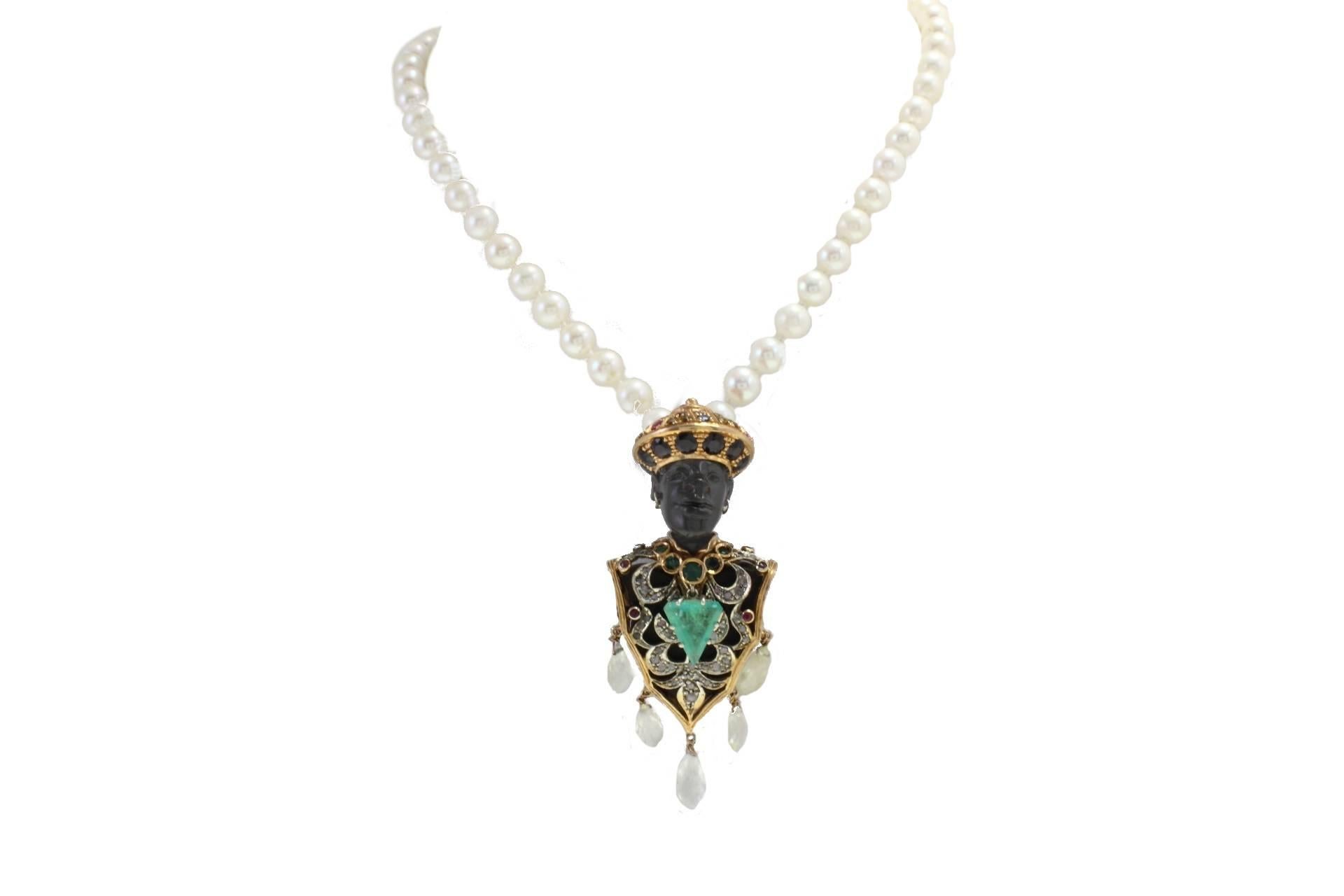 Beaded necklace linked with a Moretti Pendant in 9kt gold and silver made with ebony and embellished with diamonds, rubies, sapphires, emeralds and stones.

diamonds 0.63kt
pearls 7 mm/0.27 inch
tot weight 45.8gr
r.f.  uiih
